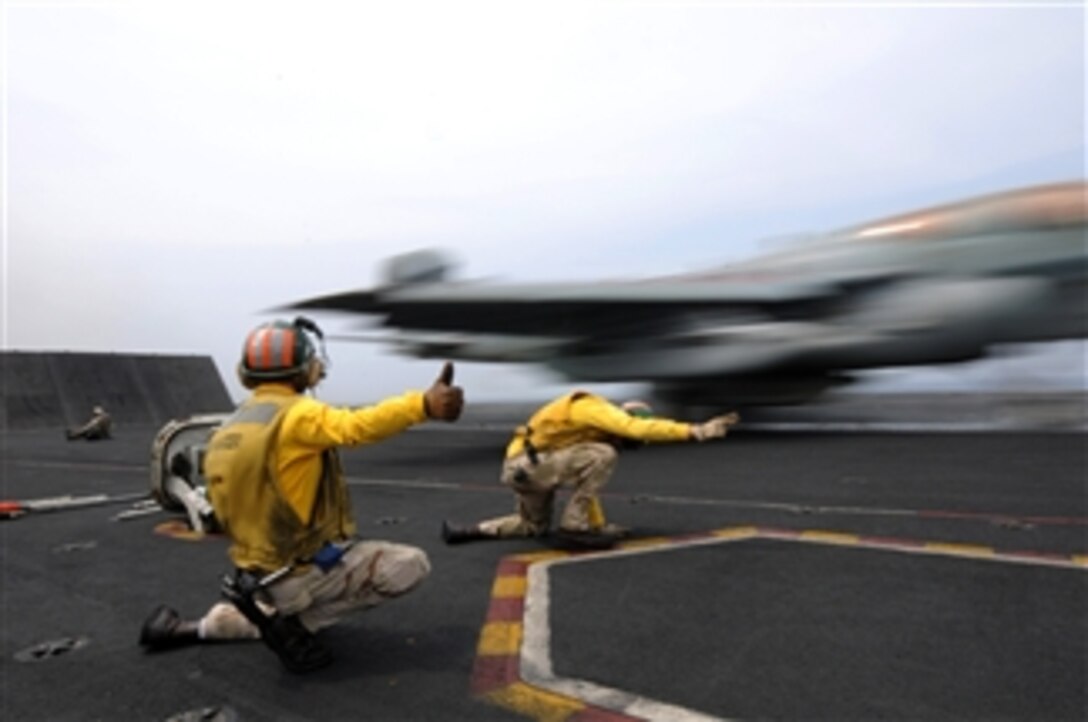 U.S. Navy Lt. Cmdr. Charles Prim gives the thumbs up sign as Lt. Douglas Steil launches an EA-6B Prowler aircraft assigned to Tactical Electronic Warfare Squadron 139 off of catapult two on the aircraft carrier USS Ronald Reagan (CVN 76) while underway in the Indian Ocean on Oct. 21, 2008.  Steil is under instruction as a "Shooter" and Prim was training him during this launch cycle.  The Ronald Reagan Carrier Strike Group is participating in exercise Malabar '08, which is designed to increase cooperation between the Indian navy and U.S. Navy while enhancing the cooperative security relationship between India and the United States.  