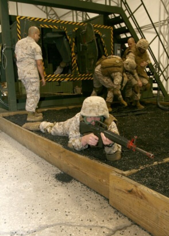 As one Marine provides security, other Marines from II Marine Expeditionary Force (Forward) evacuate a simulated casualty out of a Humvee Egress Assistance Trainer aboard Camp Lejeune, N.C., Oct. 28, 2008.  The HEAT is designed to teach deploying Marines and sailors how to properly and safely escape a vehicle when there is a roll over caused by an accident or improvised explosive device attack.