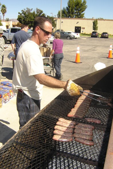 Lt. Col. Charlie Combs, 452 MXG, was one of two cooks who kept the bratwurst coming at the Brat Burn. (U.S. Air Force photo by Will Alexander)