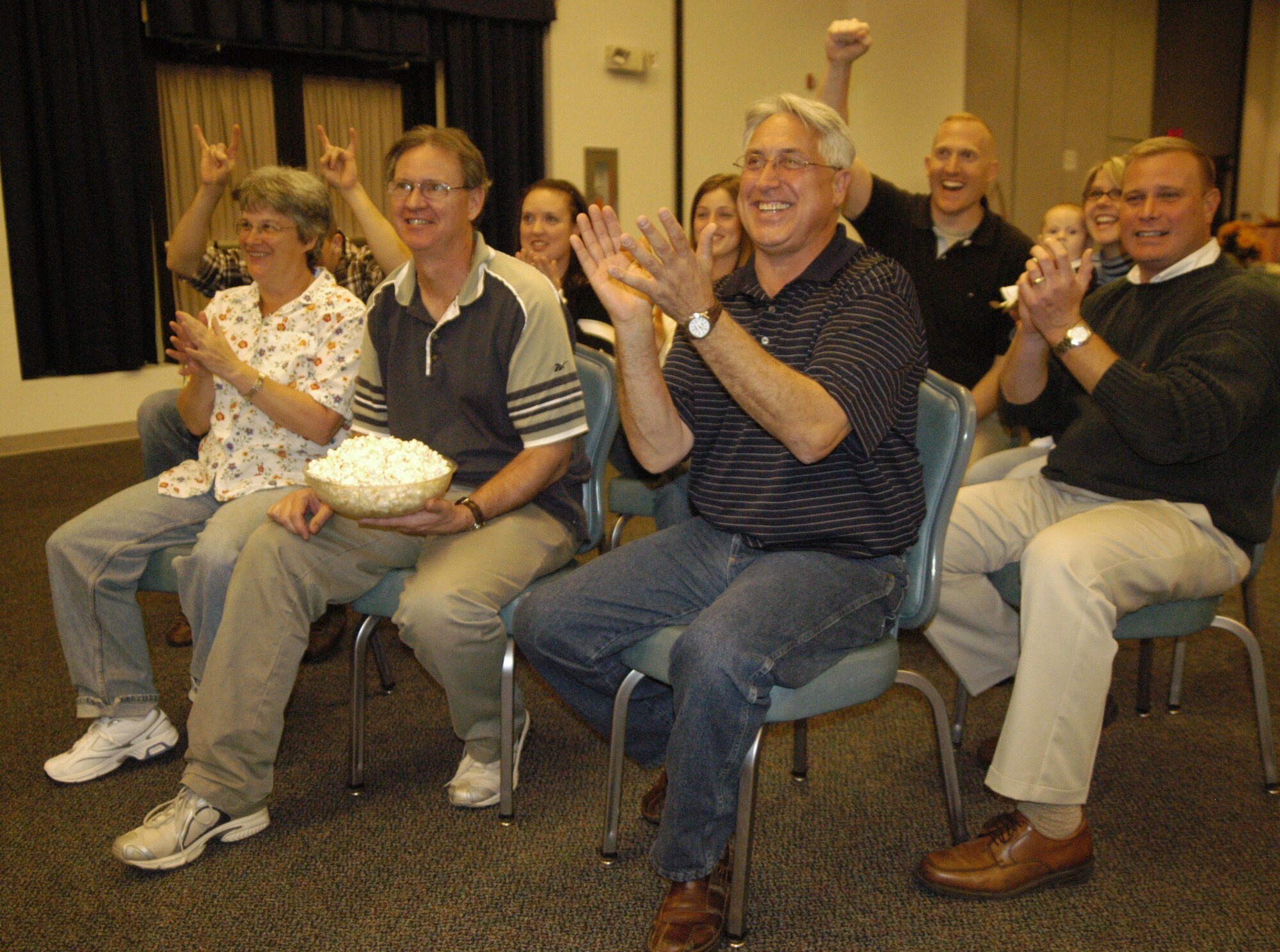 Team Dover members cheer on Airman First Class Naomi Nadeau, 436th Aircraft Maintenance Squadron, as they watch her compete in the Air Mobility Command ICONcon competition at The Landings Club.  The show was broadcast on a live feed from Scott Air Force Base, Ill., to all AMC bases.  Airman Nadeau won second place in the competition.  (U.S. Air Force photo/Airman 1st Class Shen-Chia Chu)                                