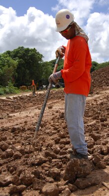 ANDERSEN AIR FORCE BASE, Guam - A Shaw Environmental, Inc. employee uses a rake to screen soil for debris at Urunao's Site 1 Oct. 28. Urunao Sites 1 and 2 were used as over-the-cliff dump sites during the World War II era. (U.S. Air Force photo by Senior Airman Shane Dunaway)
