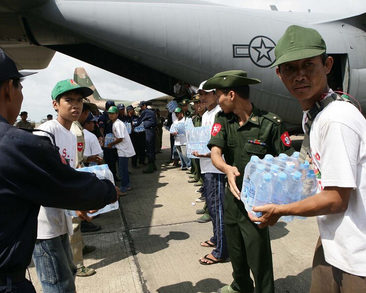 Burma service members form a line to carry water supplies off an Air Force C-130 at the Yangon International airport (Rangoon) on May 12, 2008. The plane, which is from the 36th Airlift Squadron at Yokota Air Base, Japan, carried water, food and medical supplies to provide relief to Burma after it was struck by Cyclone Nargis on May 2, 2008. (U.S. Marine Corps photo)