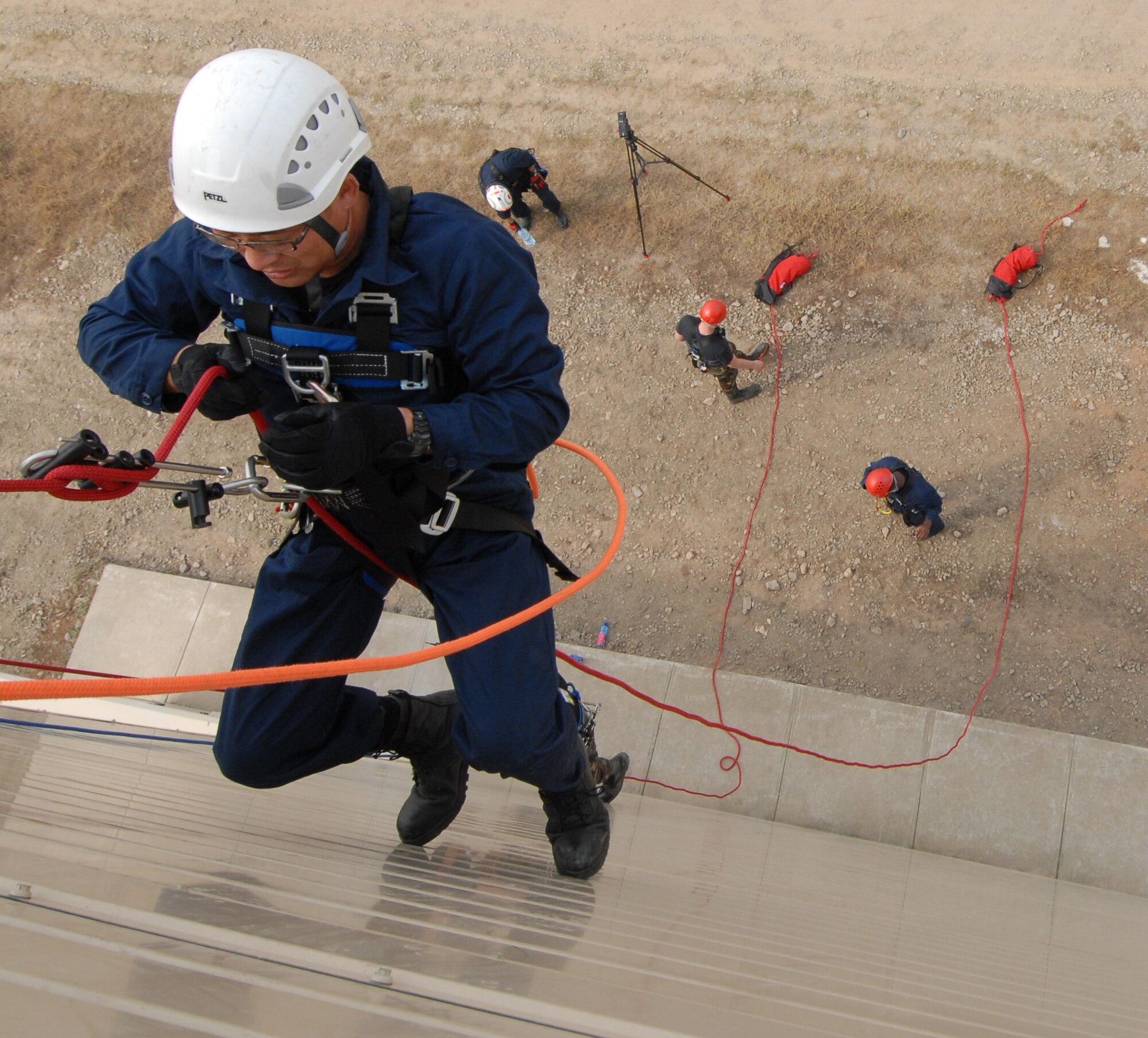 KUNSAN AIR BASE, Republic of Korea -- Kim Kisong, a national fire figher assigned to the 8th Civil Engineer Squadron, ascends a wall during the Technical One Training here, Oct 21. Air Force fire fighters and Korean national fire fighters train together regularly for ascending and descending rope rescue training. (U.S. Air Force photo/Senior Airman Gustavo Gonzalez)