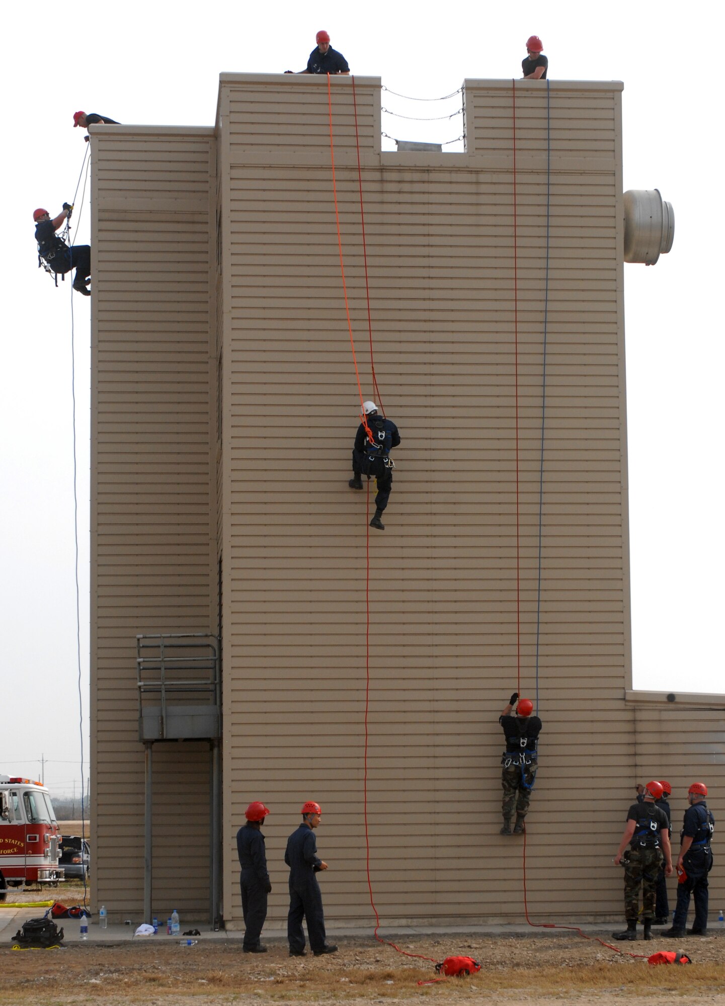 KUNSAN AIR BASE, Republic of Korea -- Air Force fire fighters and Korean national fire fighters train on  ascending and descending rope rescue during the Technical One Training here, Oct 21. (U.S. Air Force photo/Senior Airman Gustavo Gonzalez)