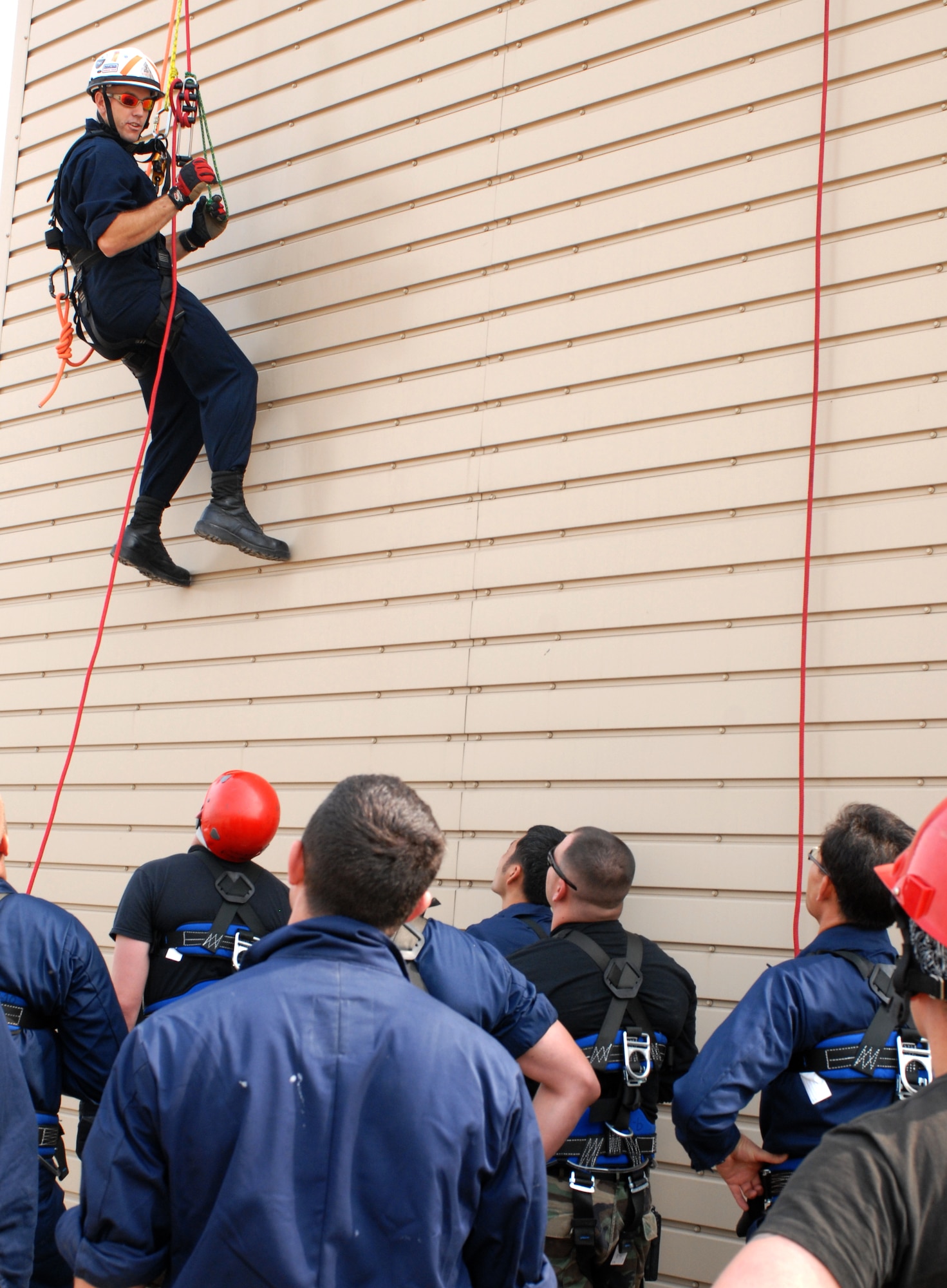 KUNSAN AIR BASE, Republic of Korea -- Staff Sgt. Christopher Waldrip, 8th Civil Engineer Squadron, ascends a wall as he instructs Air Force fire fighters and Korean national fire fighters on ascending and descending rope rescue during the Technical One Training here, Oct 21. (U.S. Air Force photo/Senior Airman Gustavo Gonzalez)