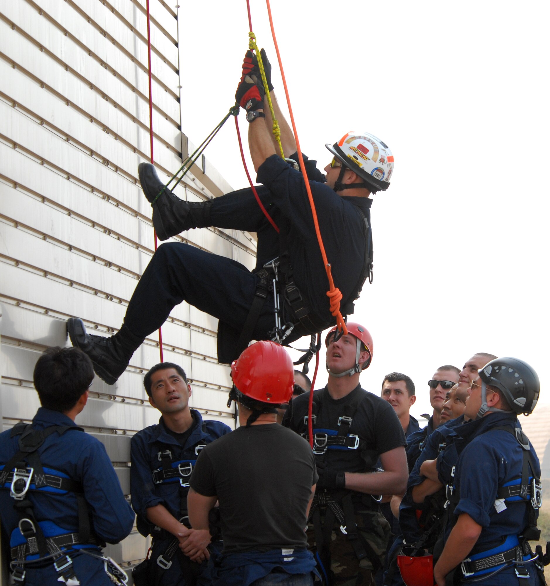 KUNSAN AIR BASE, Republic of Korea -- Staff Sgt. Christopher Waldrip, 8th Civil Engineer Squadron, ascends a wall as he instructs Air Force fire fighters and Korean national fire fighters on ascending and descending rope rescue during the Technical One Training here, Oct 21. (U.S. Air Force photo/Senior Airman Gustavo Gonzalez)