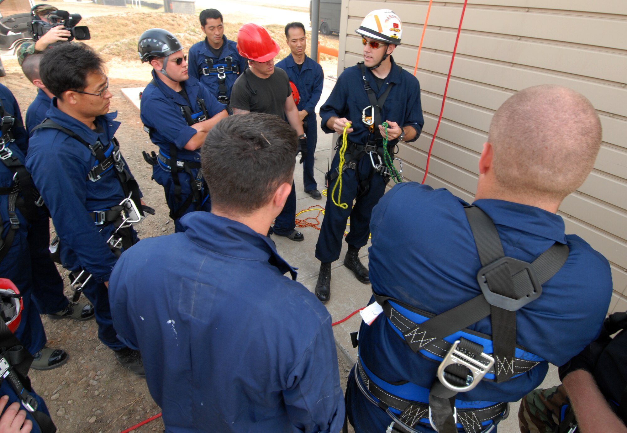 KUNSAN AIR BASE, Republic of Korea -- Staff Sgt. Christopher Waldrip, 8th Civil Engineer Squadron, instructs Air Force fire fighters and Korean national fire fighters on ascending and descending rope rescue during the Technical One Training here, Oct 21. (U.S. Air Force photo/Senior Airman Gustavo Gonzalez)