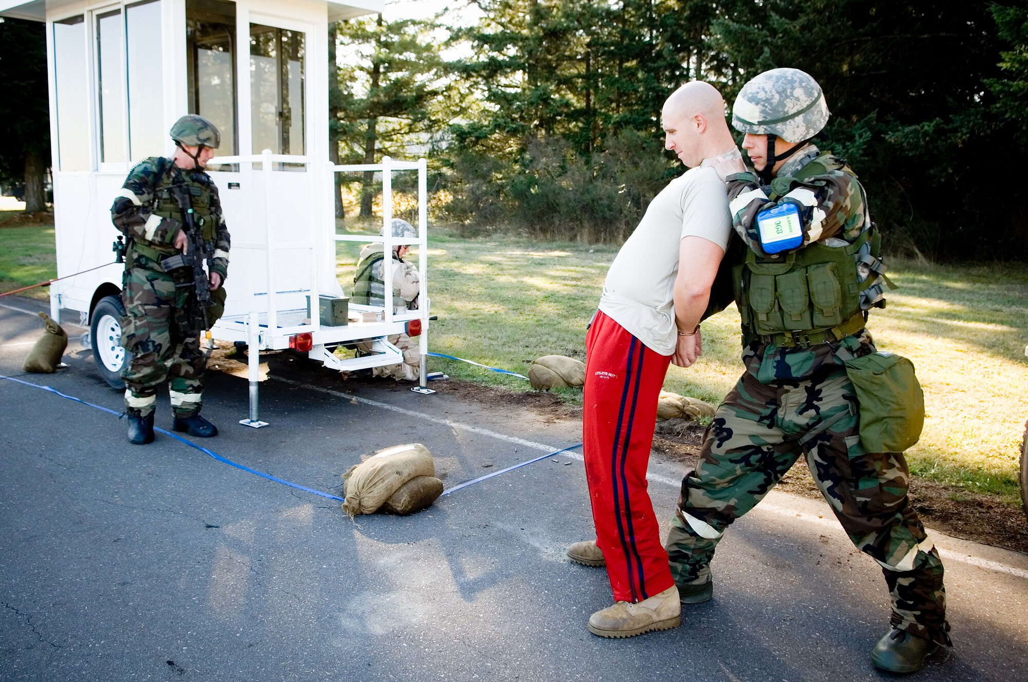 Staff Sgt. Kevin Cleveland, right, and Staff Sgt. Shane St. Laurent, both 62nd SFS, detain a suspect during the MOBEX Oct. 22. (U.S. Air Force photo/Abner Guzman)
