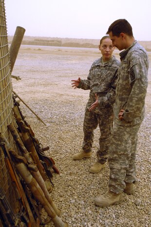 Staff Sergeant Angela “O” Olguin and Senior Airman Joshua Brum, 506th Air Expeditionary Group Explosive Ordnance Disposal flight technicians, discuss the disposal of insurgent weapons and ordnance Sept. 15. Both Airmen are forward deployed to FOB McHenry where they are embedded with soldiers of the Army’s 10th Mountain Division. Both Airmen are also deployed from Nellis Air Force Base, Nev. (U.S. Air Force photo/Tech. Sgt. Jeff Walston)