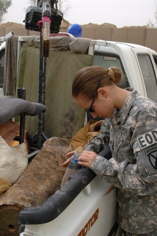 Staff Sergeant Angela Olguin, 506th Air Expeditionary Group Explosive Ordnance Disposal flight journeyman, inspects explosive remnants local Iraqi policeman brought to FOB McHenry Sept. 15. Sergeant Olguin is one of six 506th EOD Airmen forward deployed to FOB McHenry where they are embedded with soldiers of the Army’s 10th Mountain Division.  She is deployed from Nellis Air Force Base, Nev., and calls Cortez, Colo., home. (U.S. Air Force photo/Tech. Sgt. Jeff Walston)