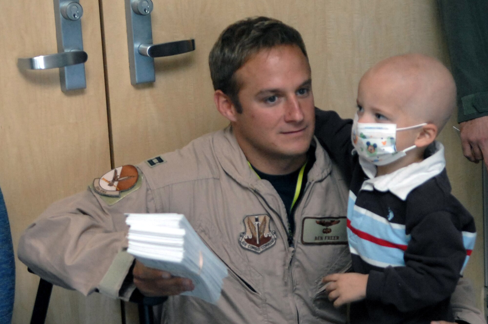 CREECH AFB Nev. – Captain Ben Freer, 15th Reconnaissance Squadron, pilot, holds his 3-year-old son Ethan, during a bone marrow drive registration held on base Oct. 22. Ethan has been diagnosed with Stage Four Neuroblastoma Cancer. (U.S. Air Force photo/Senior Airman Jason Huddleston)