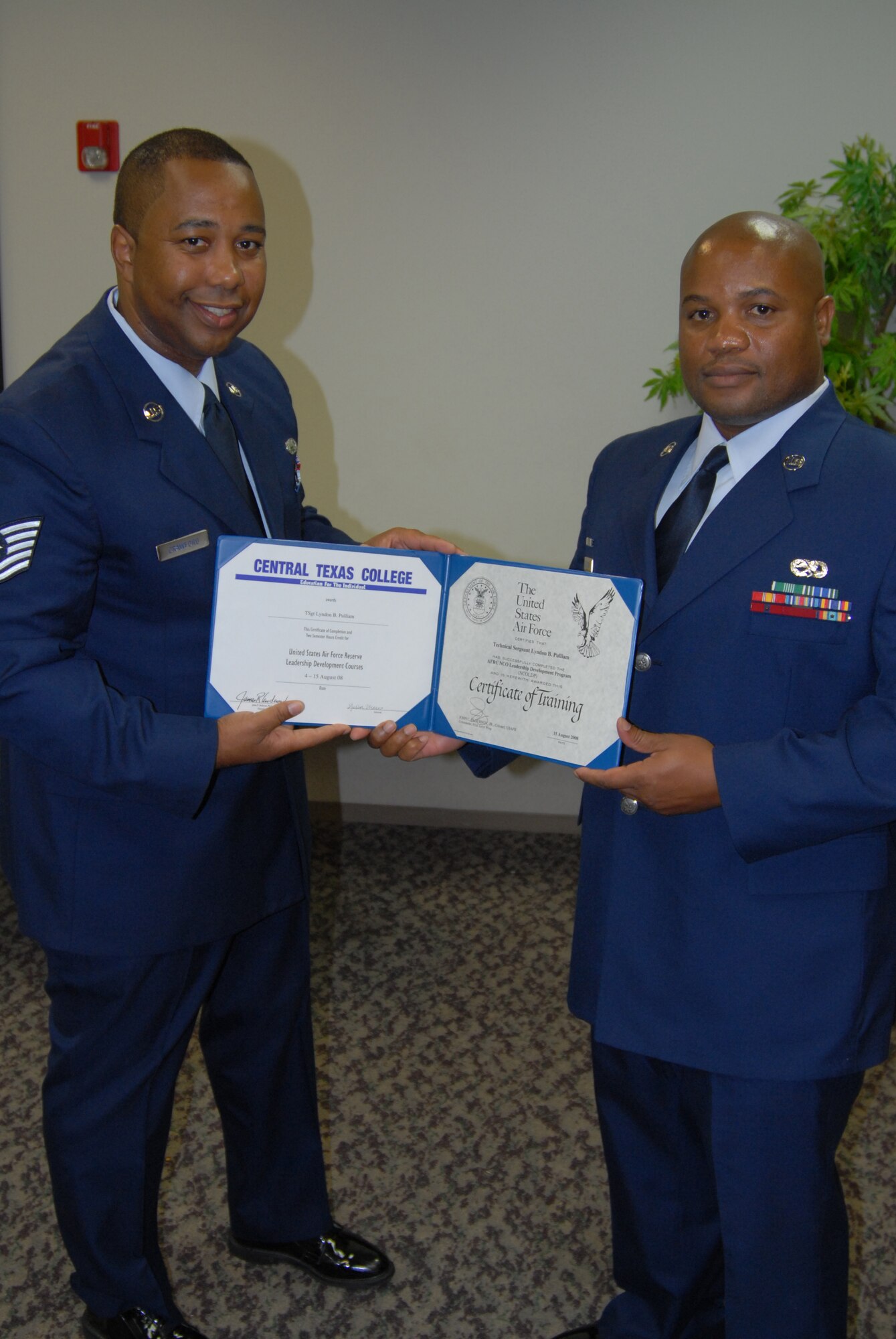 A beautiful education certificate goes to Tech. Sgt. Lyndon Pulliam, one more dedicated student, as another 932nd Airlift Wing member graduates! Tech. Sgt. Marlon Crawford (left), from the 932nd Airlift Wing's education office, congratulates the new NCO Leadership Develop course graduate recently.. (U.S. Air Force photo/Maj. Stan Paregien) 