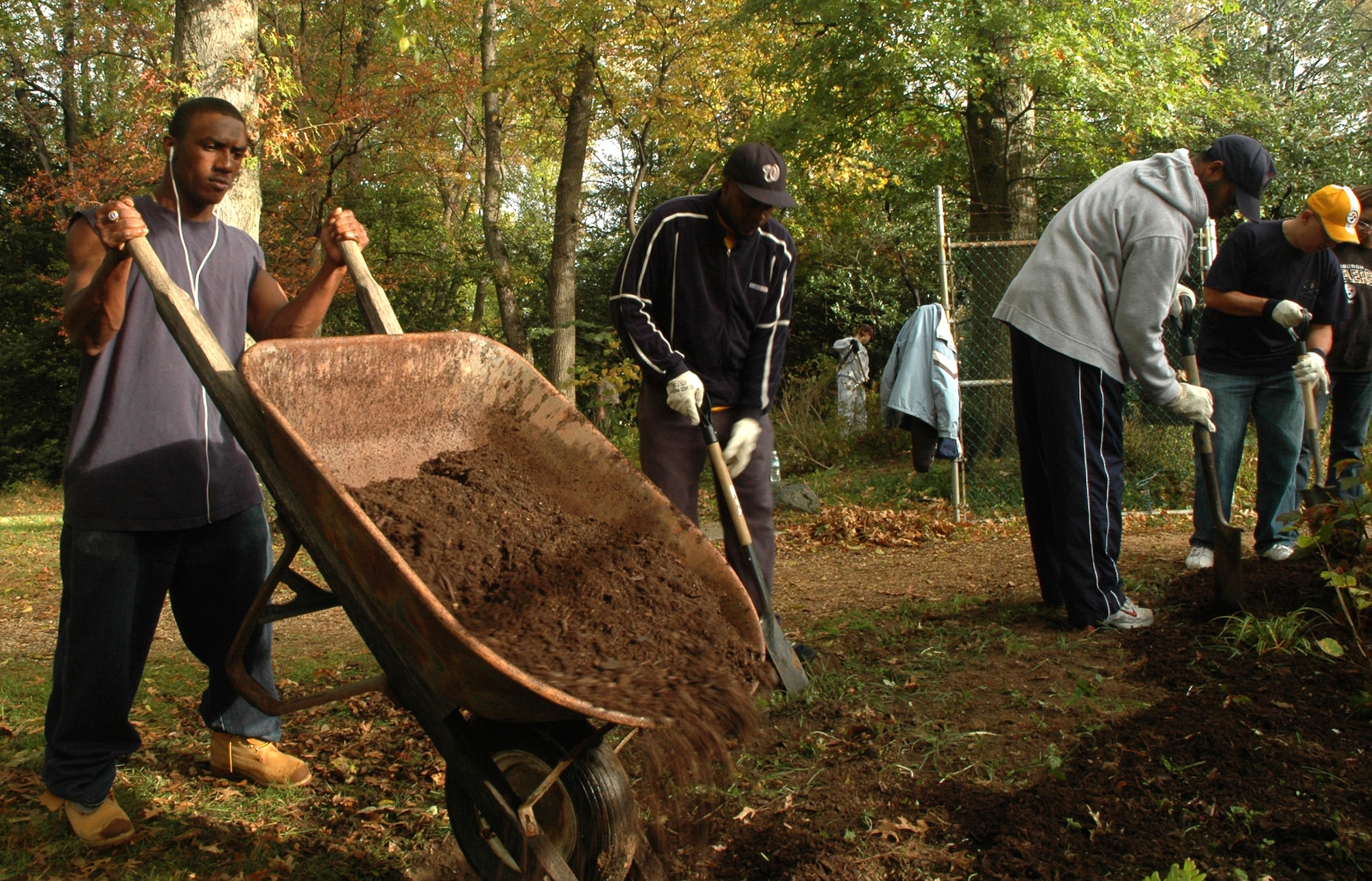 Airman 1st Class Jo Van J. Descartes, 11th Security Forces Squadron, pours mulch into a flowerbed Oct. 25 at Kenilworth Aquatic Garden in Washington, D.C. Airman Descartes was one of 176 servicemembers who volunteered at the garden as part of a joint service project for national "Make a Difference Day."  (U.S. Air Force photo/R. Michael Longoria)