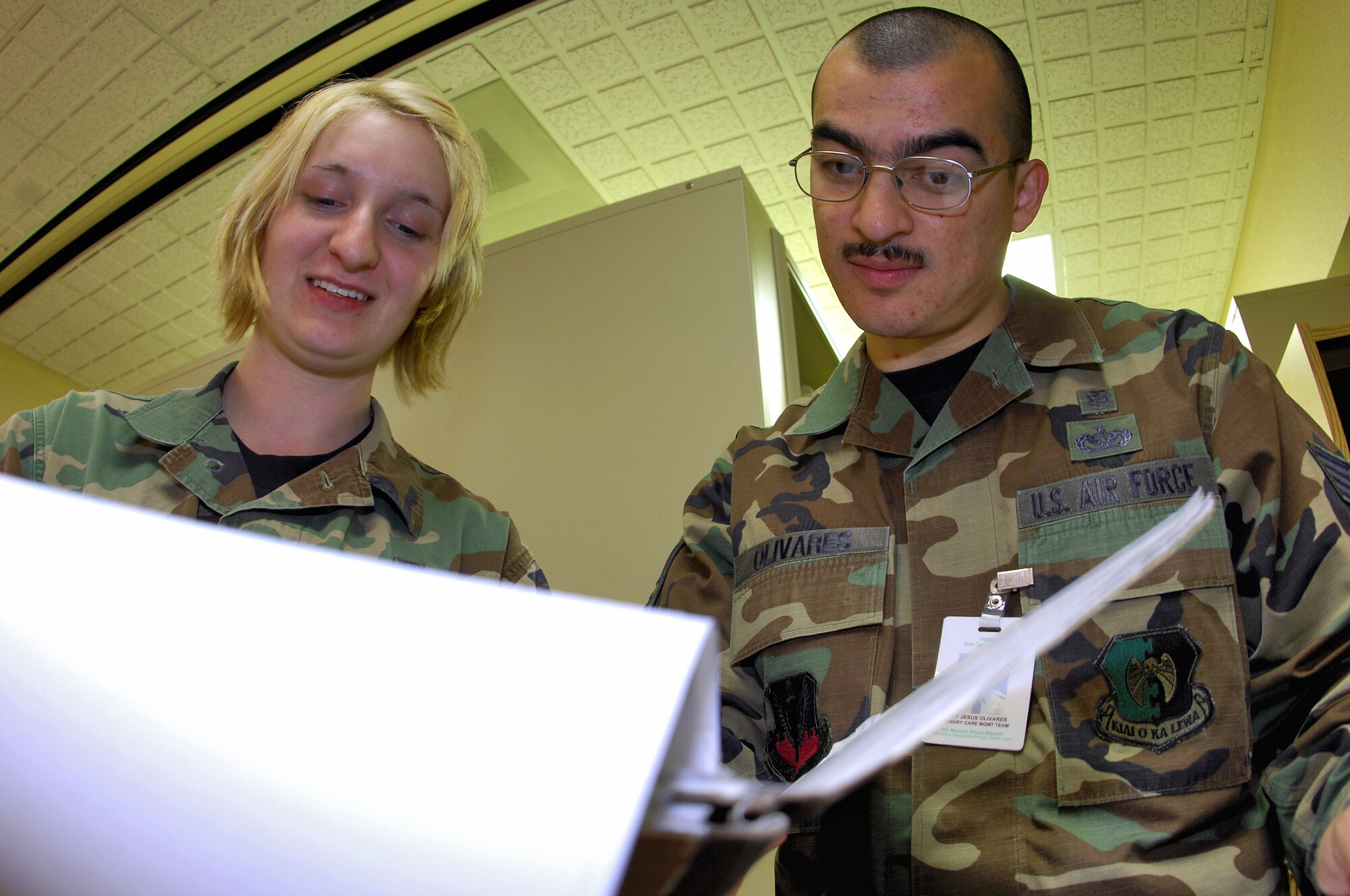 MINOT AIR FORCE BASE, N.D. -- Staff Sgt. Jesus Olivares, 5th Medical Support Squadron outpatient records noncommissioned officer-in-charge, looks over Airman 1st Class Heather Griffin’s, 5th MDSS outpatient clerk, work organizing a patient’s records here recently. Outpatient clerk is one of the functions performed by health-service managers. Health-service managers maintain everything from patient records to medically preparing Airmen for upcoming deployments. (U.S. Air Force photo by Airman 1st Class Benjamin Stratton)