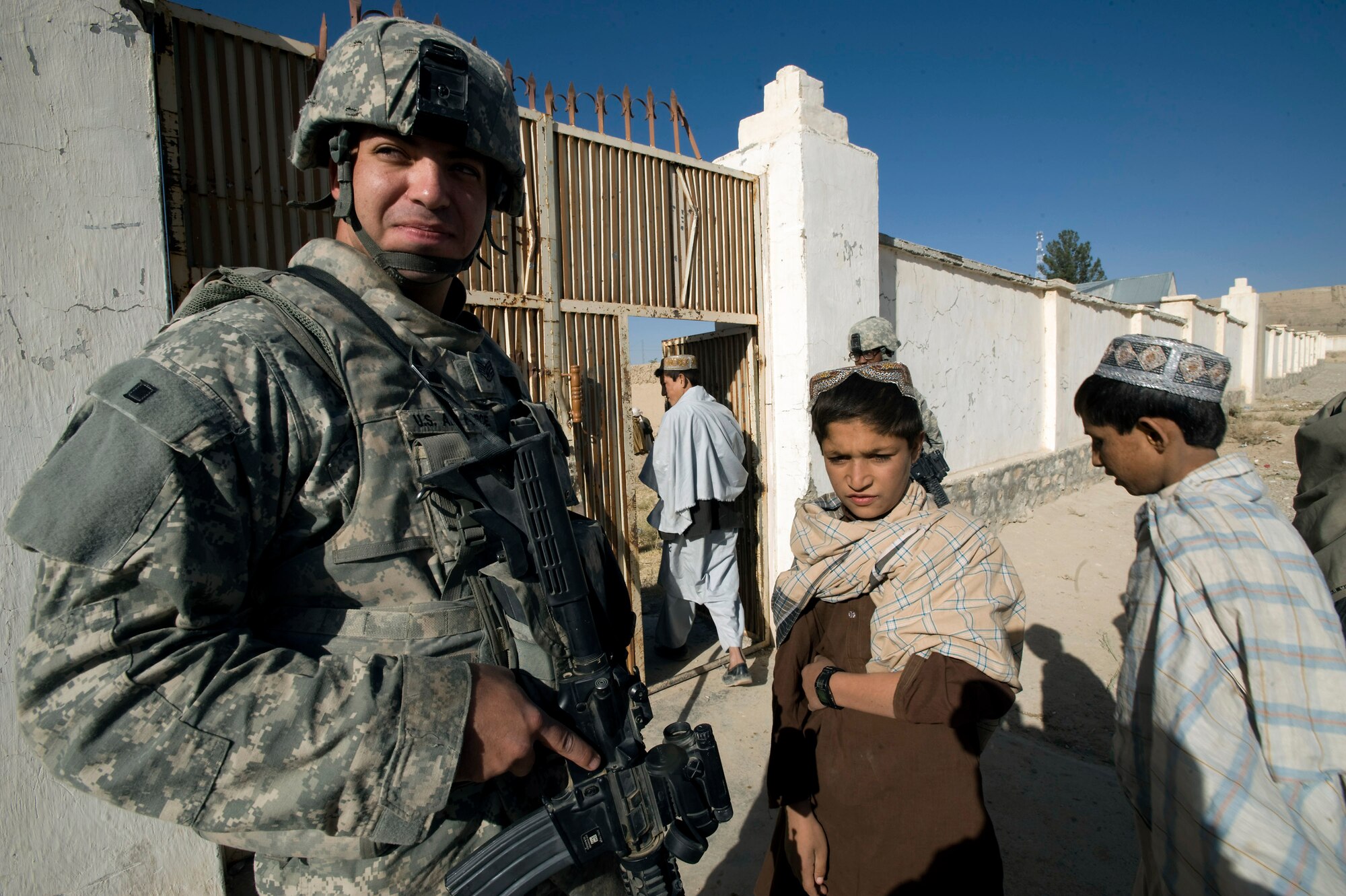 Staff Sgt. Joe Montano provides security at the entrance of the Kuchi compound during a veterinary medical outreach conducted by the Zabul Provincial Reconstruction Team Oct. 18 in Qalat, Afghanistan. The PRT members offered free deworming and vitamin supplements during the VMO. Sergeant Montano provides security for the PRT when they are working within the province. He is an F-15 Eagle crew chief deployed from Nellis Air Force Base, Nev. (U.S. Air Force photo/Master Sgt. Keith Brown) 
