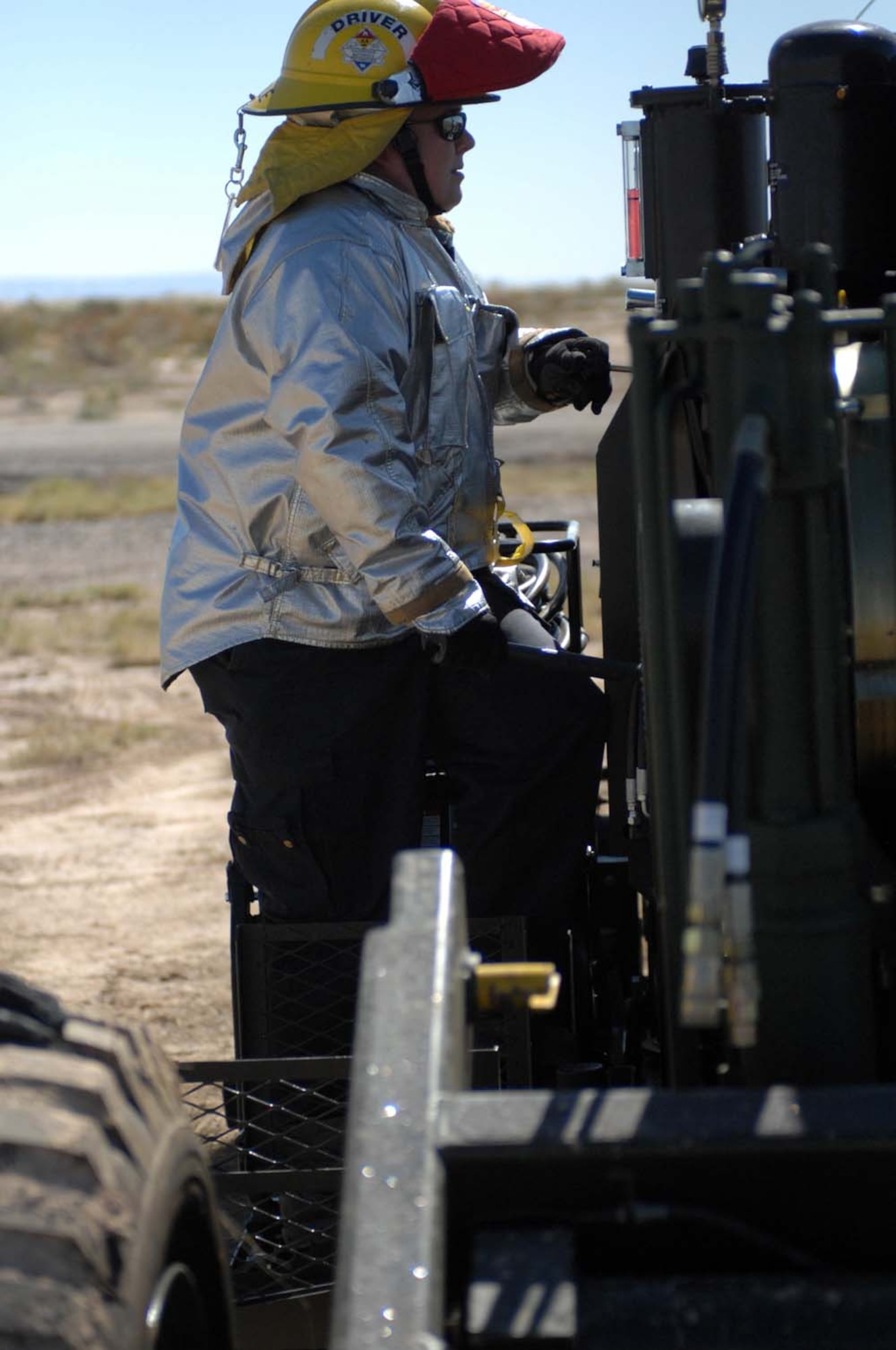 Mr. Keven Mickle, 49th Civil Engineer Squadron firefighter, starts the engine of rhe new mobility aircraft arresting system at Holloman Air Force Base, N.M., before its certification October 23. (U.S. Air Force photo/ Staff Sgt. Terri Barriere)
