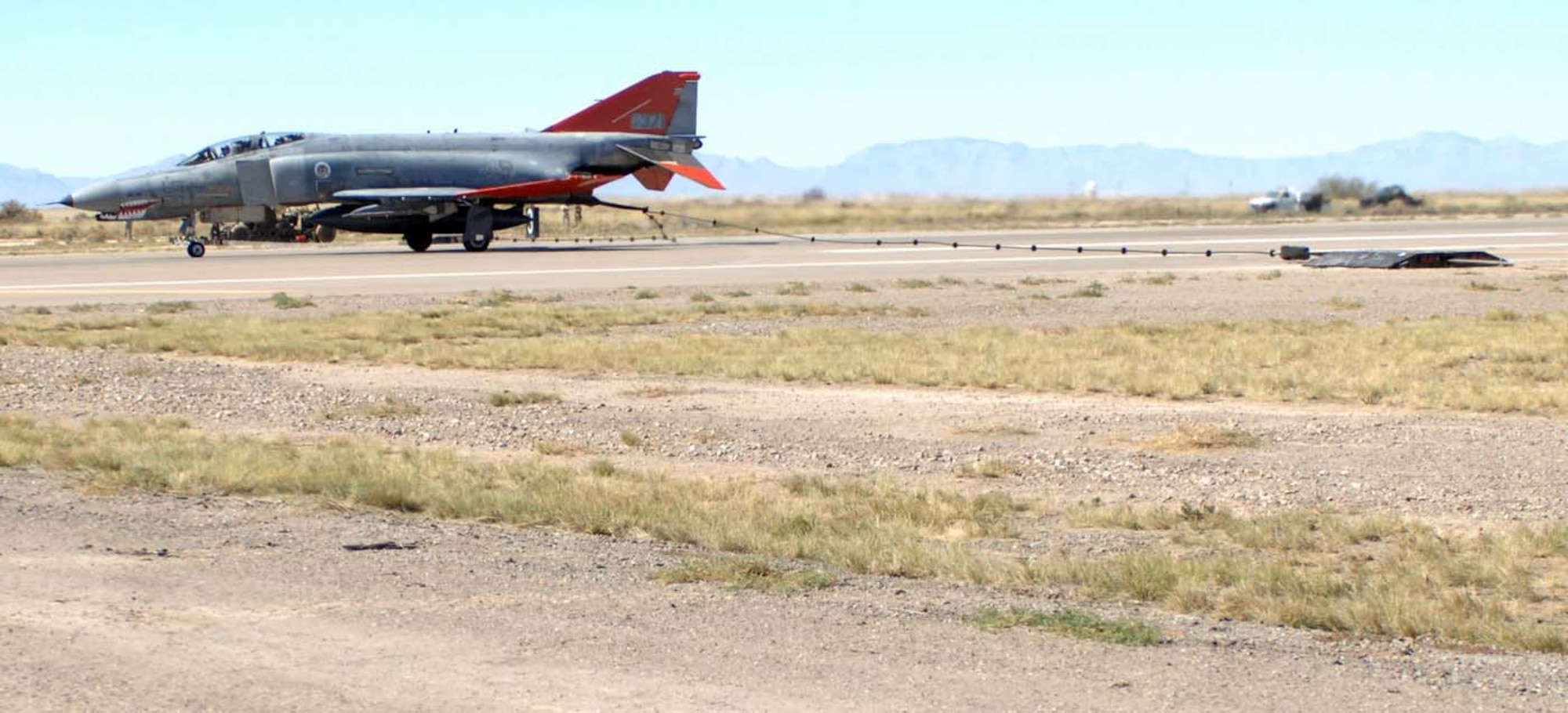 A QF-4 Drone engages the new aircraft arresting system at Holloman Air Force Base, N.M., October 23 after simulating an emergency landing on the flightline during the certfication of the new system.(U.S. Air Force photo/ Staff Sgt. Terri Barriere)