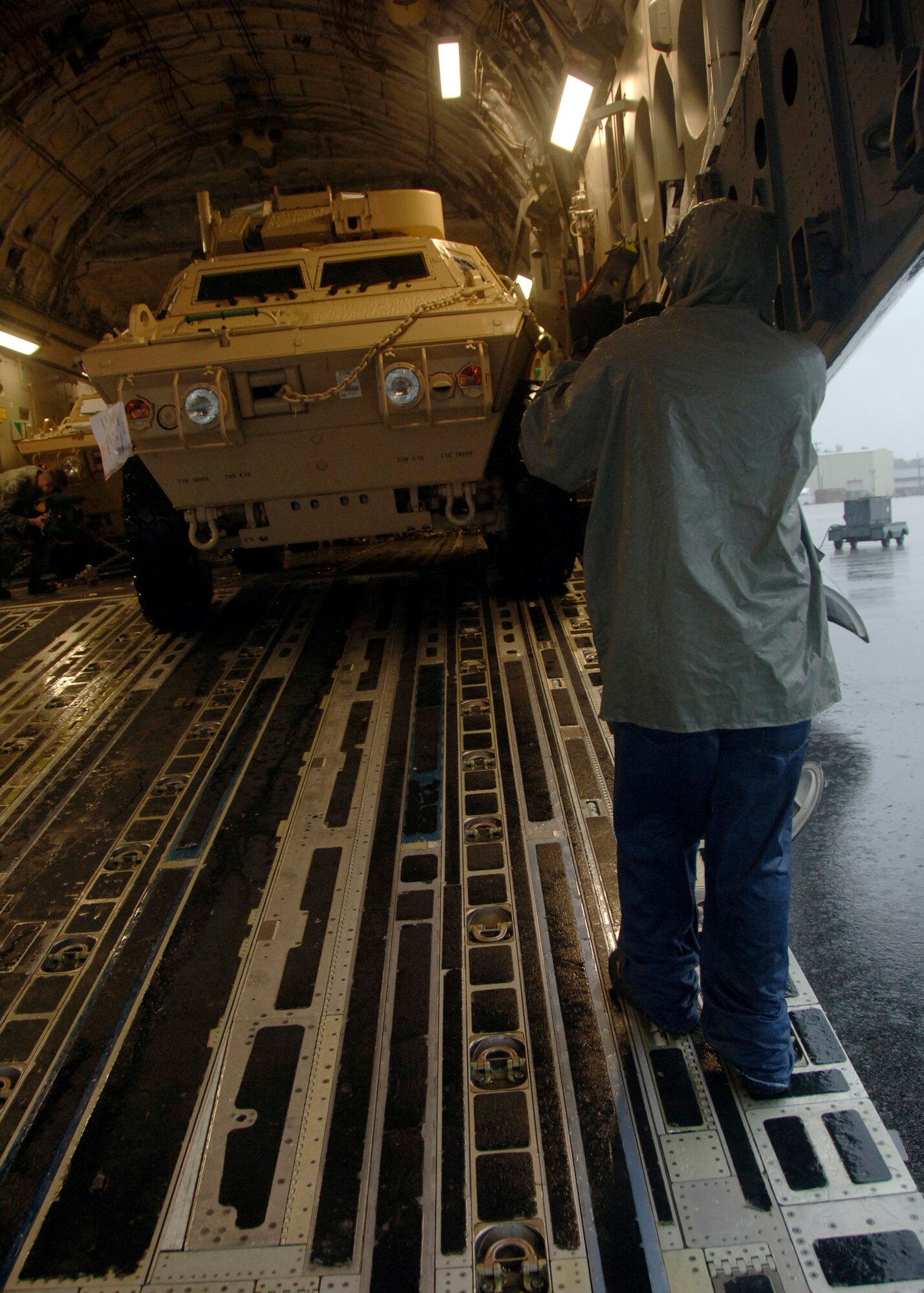 Corrie Frazier guides an ASV toward the back of a C-17 on the Charleston AFB flightline Oct. 24. The ASV is a four-wheel-drive vehicle that provides ballistic protection to warfighters who are using them against various threats. Mr. Frazier is with the 437th Aerial Port Squadron. (U.S. Air Force photo/Airman 1st Class Timothy Taylor)
