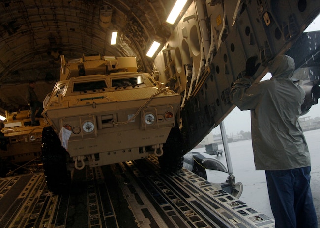 Corrie Frazier guides an ASV toward the back of a C-17 on the Charleston AFB flightline Oct. 24. The Armored Security Vehicle is a four-wheel-drive vehicle that provides ballistic protection to warfighters who are using them against various threats. Mr. Frazier is with the 437th Aerial Port Squadron. (U.S. Air Force photo/Airman 1st Class Timothy Taylor)
