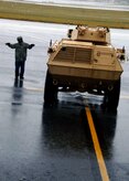 Corrie Frazier guides an ASV toward the back of a C-17 on the Charleston AFB flightline Oct. 24. The Armored Security Vehicle is a four-wheel-drive vehicle that provides ballistic protection to warfighters who are using them against various threats. Mr. Frazier is with the 437th Aerial Port Squadron. (U.S. Air Force photo/Airman 1st Class Timothy Taylor)