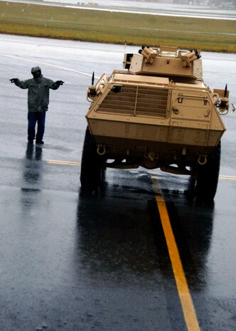 Corrie Frazier guides an ASV toward the back of a C-17 on the Charleston AFB flightline Oct. 24. The Armored Security Vehicle is a four-wheel-drive vehicle that provides ballistic protection to warfighters who are using them against various threats. Mr. Frazier is with the 437th Aerial Port Squadron. (U.S. Air Force photo/Airman 1st Class Timothy Taylor)