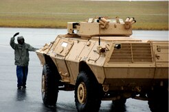 Corrie Frazier guides an ASV toward the back of a C-17 on the Charleston AFB flightline Oct. 24. The Armored Security Vehicle is a four-wheel-drive vehicle that provides ballistic protection to warfighters who are using them against various threats. Mr. Frazier is with the 437th Aerial Port Squadron. (U.S. Air Force photo/Airman 1st Class Timothy Taylor)