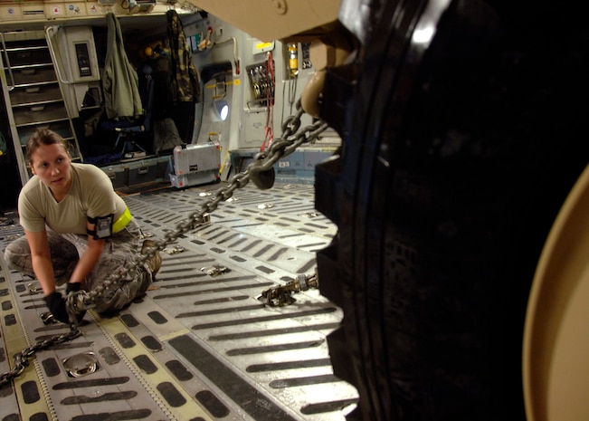 Senior Airman Ashley Kelly tightens a clamp to secure an Armored Security Vehicle to the bed of a C-17 on the Charleston AFB flightline Oct. 24. The ASV is a four-wheel-drive vehicle that provides ballistic protection to warfighters who are using them against various threats in forward deployed locations. Airman Kelly is with the 437th Aerial Port Squadron. (U.S. Air Force photo/Airman 1st Class Timothy Taylor)
