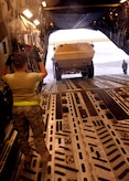 Senior Airman Ashley Kelly guides an M1117 ASV into the back of a C-17 on the Charleston AFB flightline Oct. 24. The Armored Security Vehicle is a four-wheel-drive vehicle that provides ballistic protection to warfighters who are using them against various threats. Airman Kelly is with the 437th Aerial Port Squadron. (U.S. Air Force photo/Airman 1st Class Timothy Taylor)