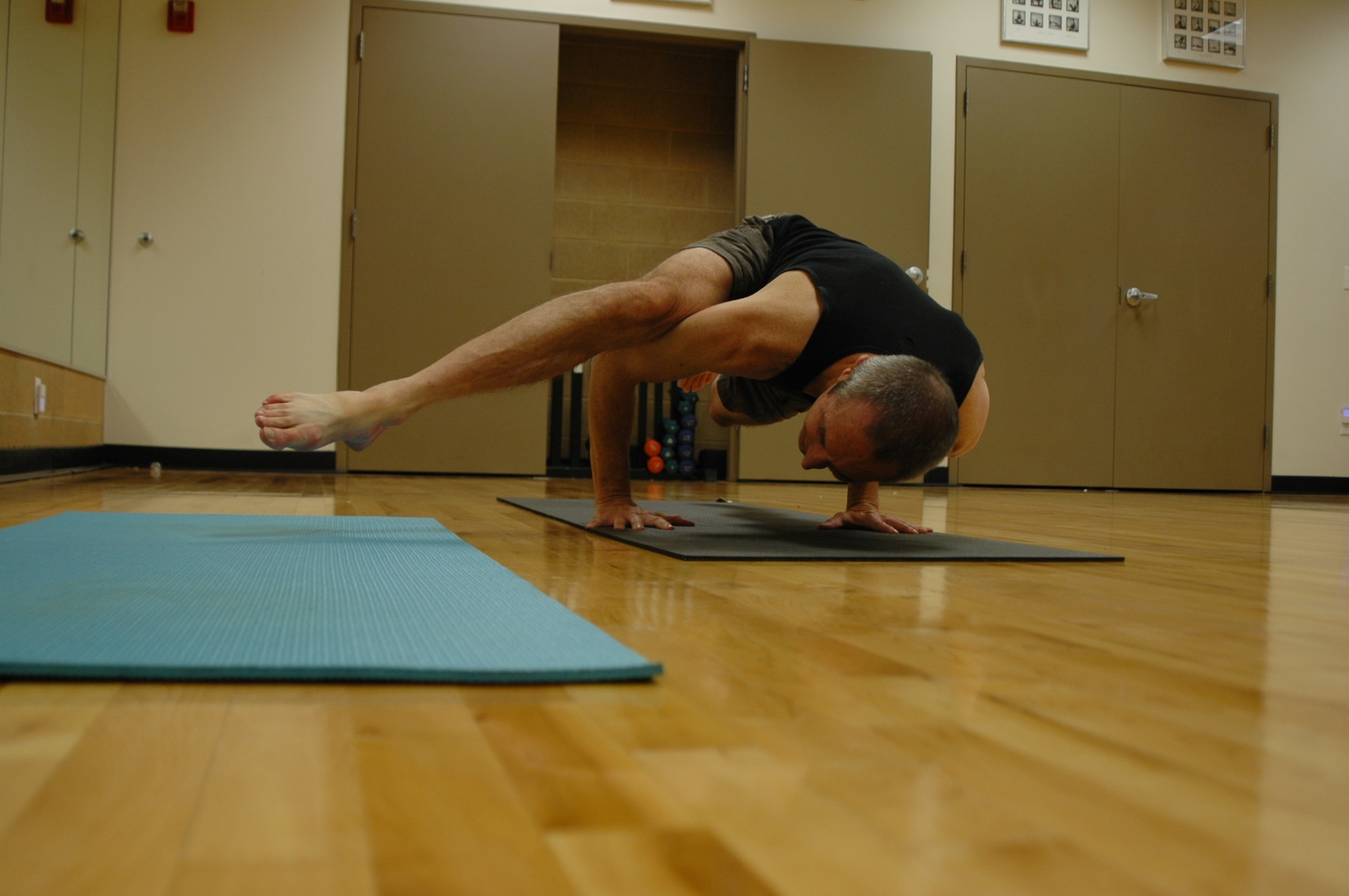 Les a yoga instructor at the warrior fitness center, performs a pose from at the Warrior Fitness Center