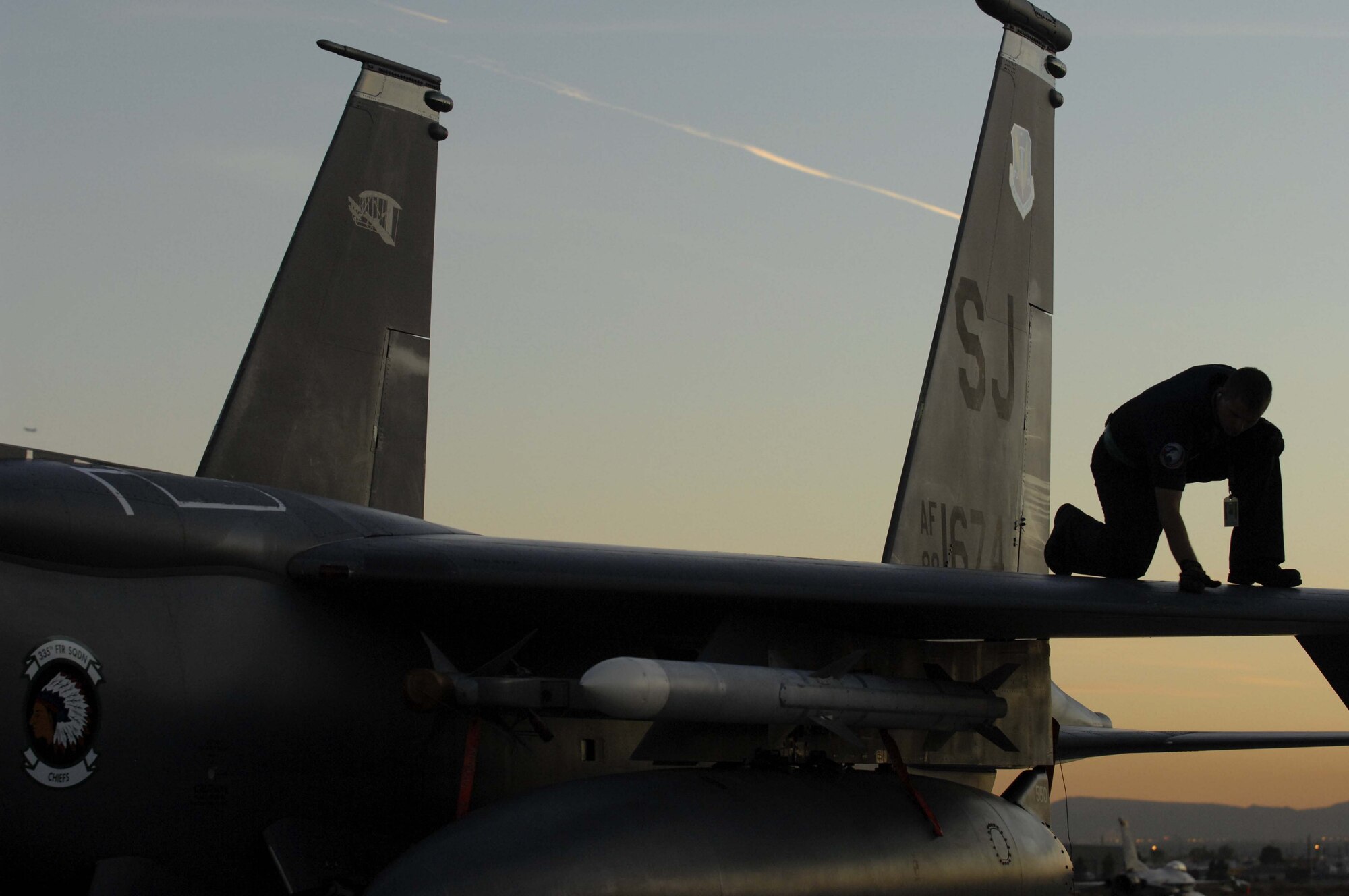 Senior Airman Ken Badertscher, an F-15E crew chief assigned to the 4th Aircraft Maintenance Squadron, Seymour Johnson Air Force Base, N.C., inspects his aircraft for loose fasteners after a two hour sortie during Red Flag 09-1 Nellis AFB, NV., Oct. 24. Red Flag is a multi-national exercise providing a realistic environment to practice combat scenarios. The experience gained during the exercise is vital to the survival of pilots in combat.(U.S. Air Force photo by Senior Airman Larry E. Reid Jr.)