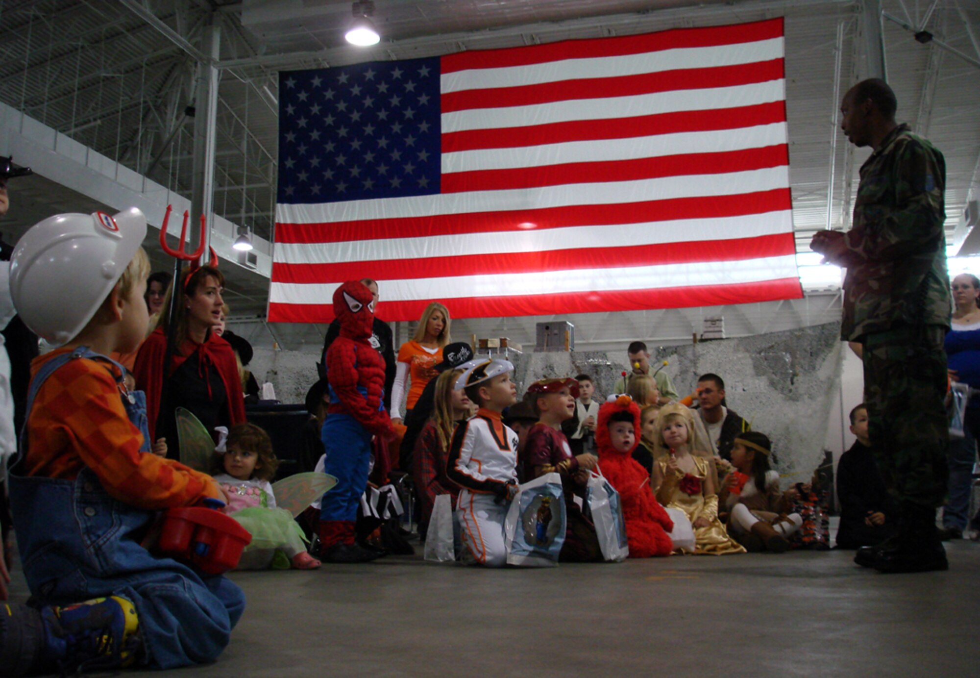 Family members from the 621st Contingency Response Wing hear Halloween safety tips during the first Children’s Spooktacular held at the Global Response Deployment Center Oct. 25. Children dressed as their favorite characters, ghosts, and goblins and enjoyed a spooky walk, a duck bath, and a spider ring toss. (U.S. Air Force photo/Staff Sgt. Francis Lalic)