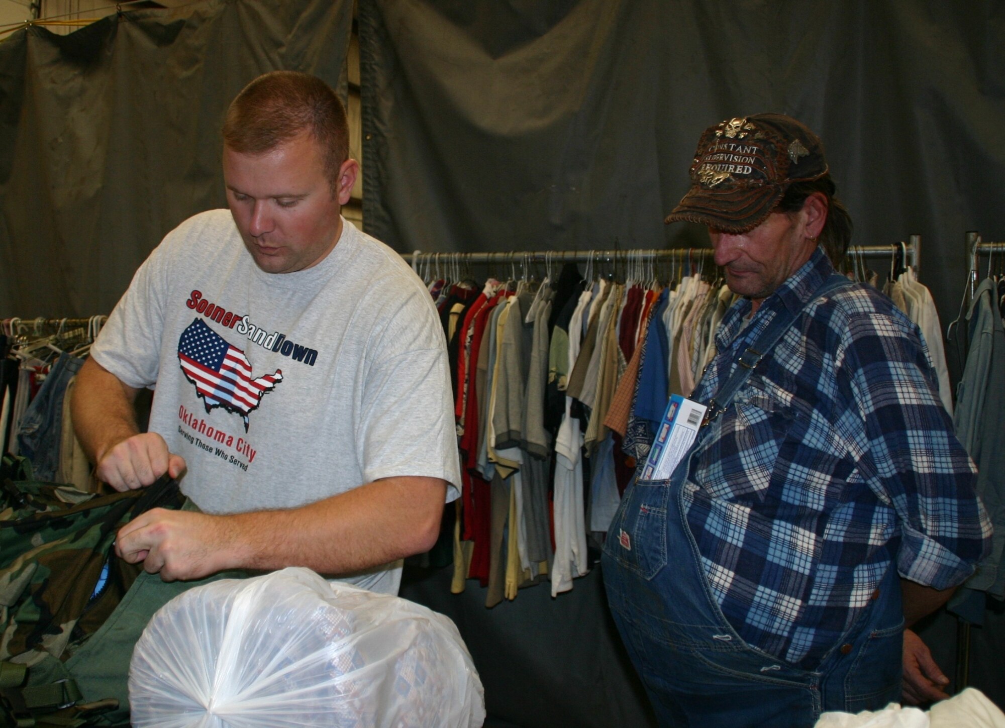 Staff Sgt. David Bizeau, 72 Contracting Squadron, helps a veteran fill his backpack with clothing and necessities. Photo courtest of 1Lt Kinder Blacke.