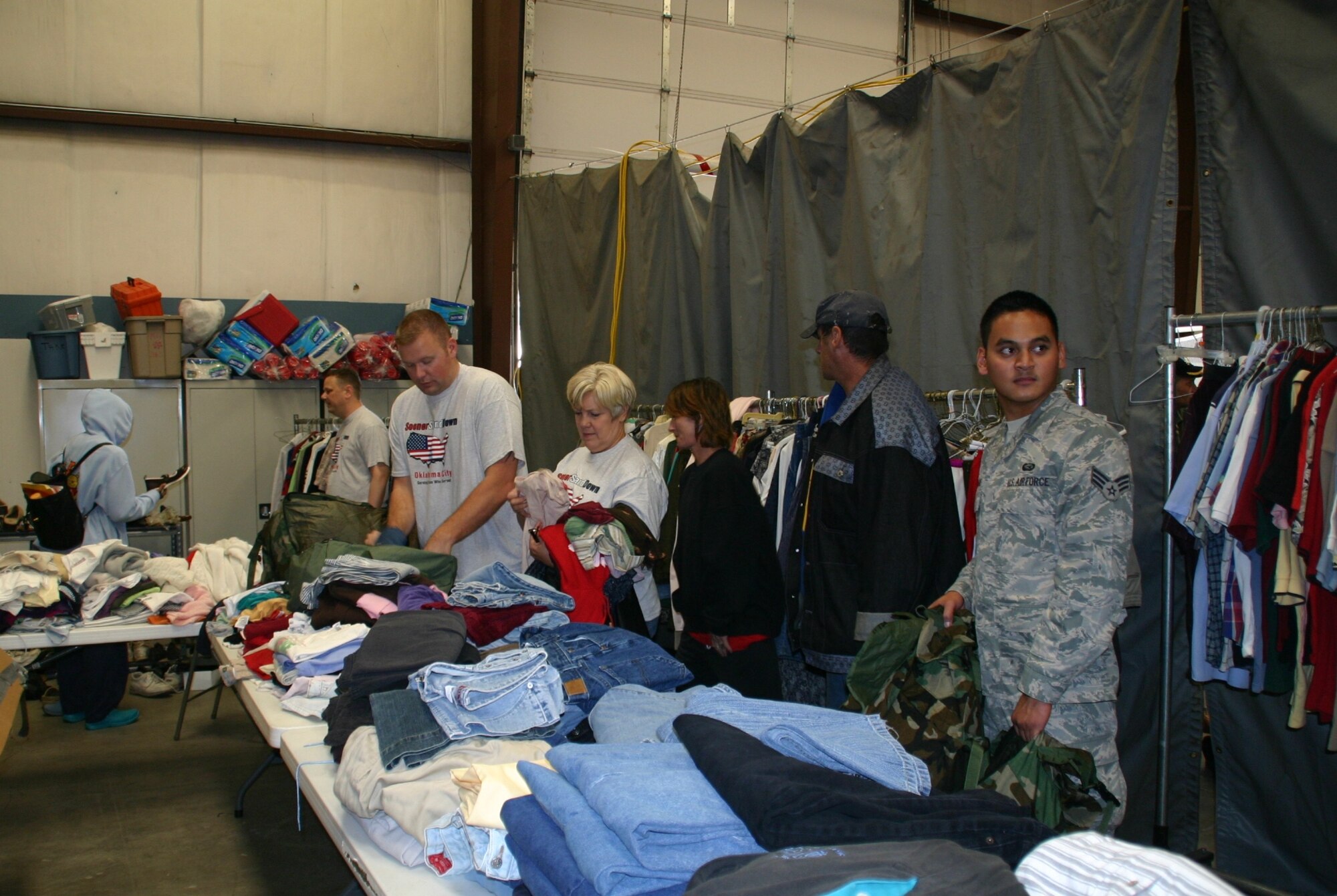 Volunteers at the Sooner Stand Down help homeless veterans find clothing and shoes to fill their backpacks. Photo courtesy of 1Lt Kinder Blacke.