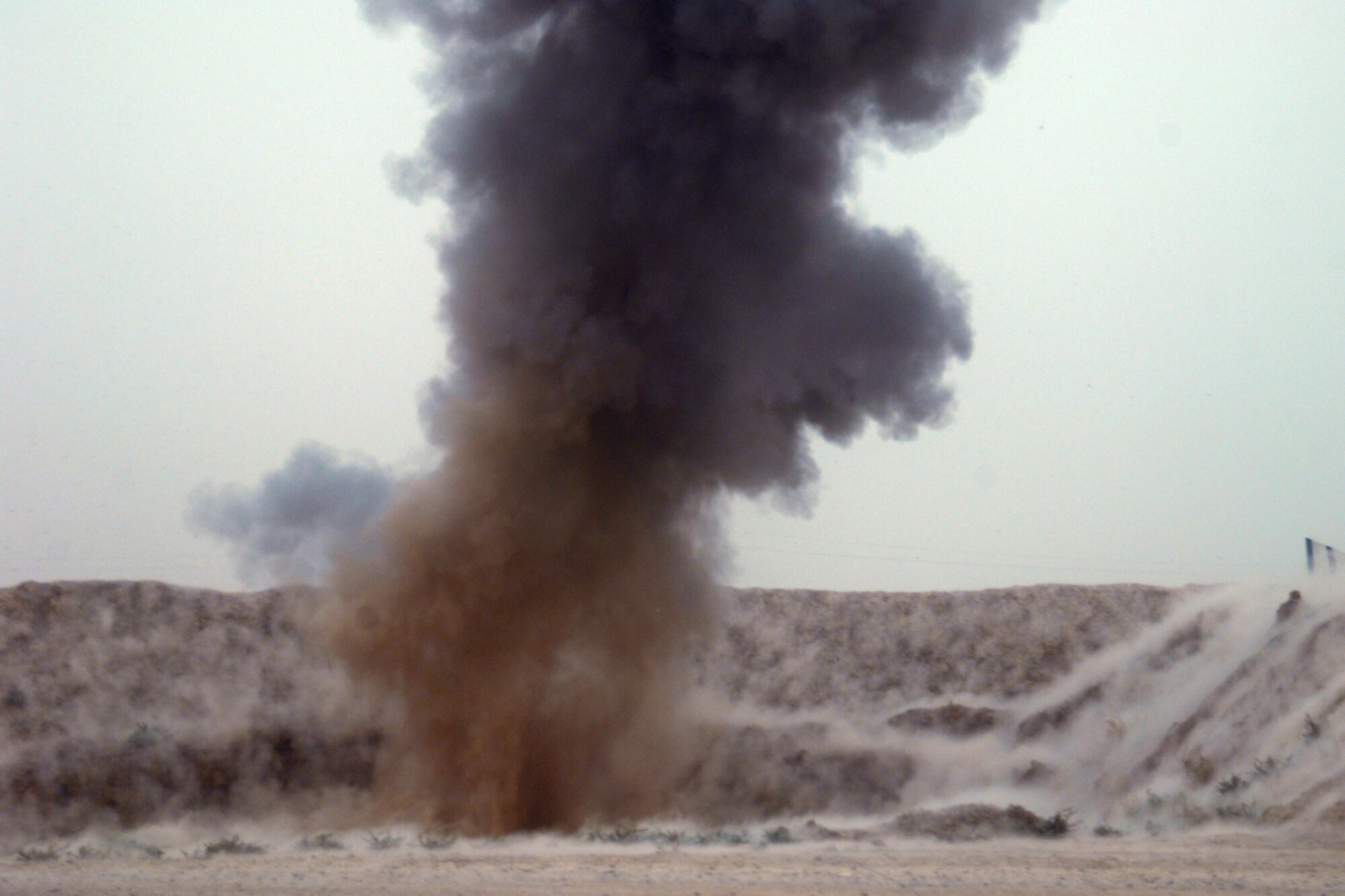 KIRKUK REGIONAL AIR BASE, Iraq – A controlled detonation at FOB McHenry by members of the 506th Air Expeditionary Group Explosive Ordnance Disposal flight destroys insurgent ordnance Sept 15.  Six 506th EOD Airmen are embedded with soldiers of the Army’s 10th Mountain Division at FOB McHenry where they perform route clearance duties. (U.S. Air Force photo/Tech. Sgt. Jeff Walston)