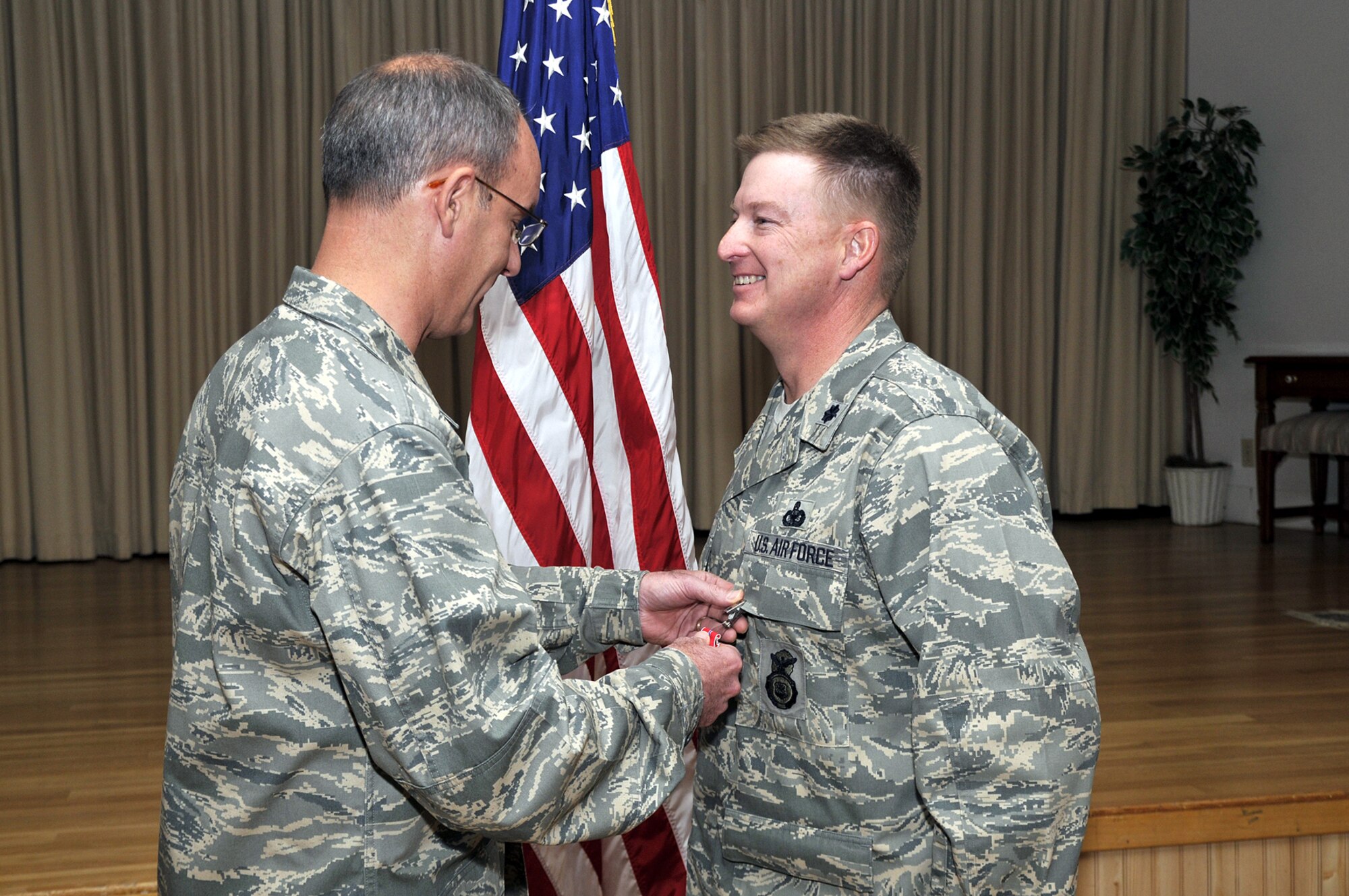 Col. Michael Fortney, 341st Missile Wing commander, presents Lt. Col. Lynden Skinner, 341st Security Forces Group deputy commander, with a Bronze Star Medal prior to the start of a commander’s call Oct. 24. Colonel Skinner was awarded the Bronze Star Medal for duties he performed while deployed in support of Operation Iraqi Freedom from May to November 2007. (U.S.  Air Force photo/John Turner)