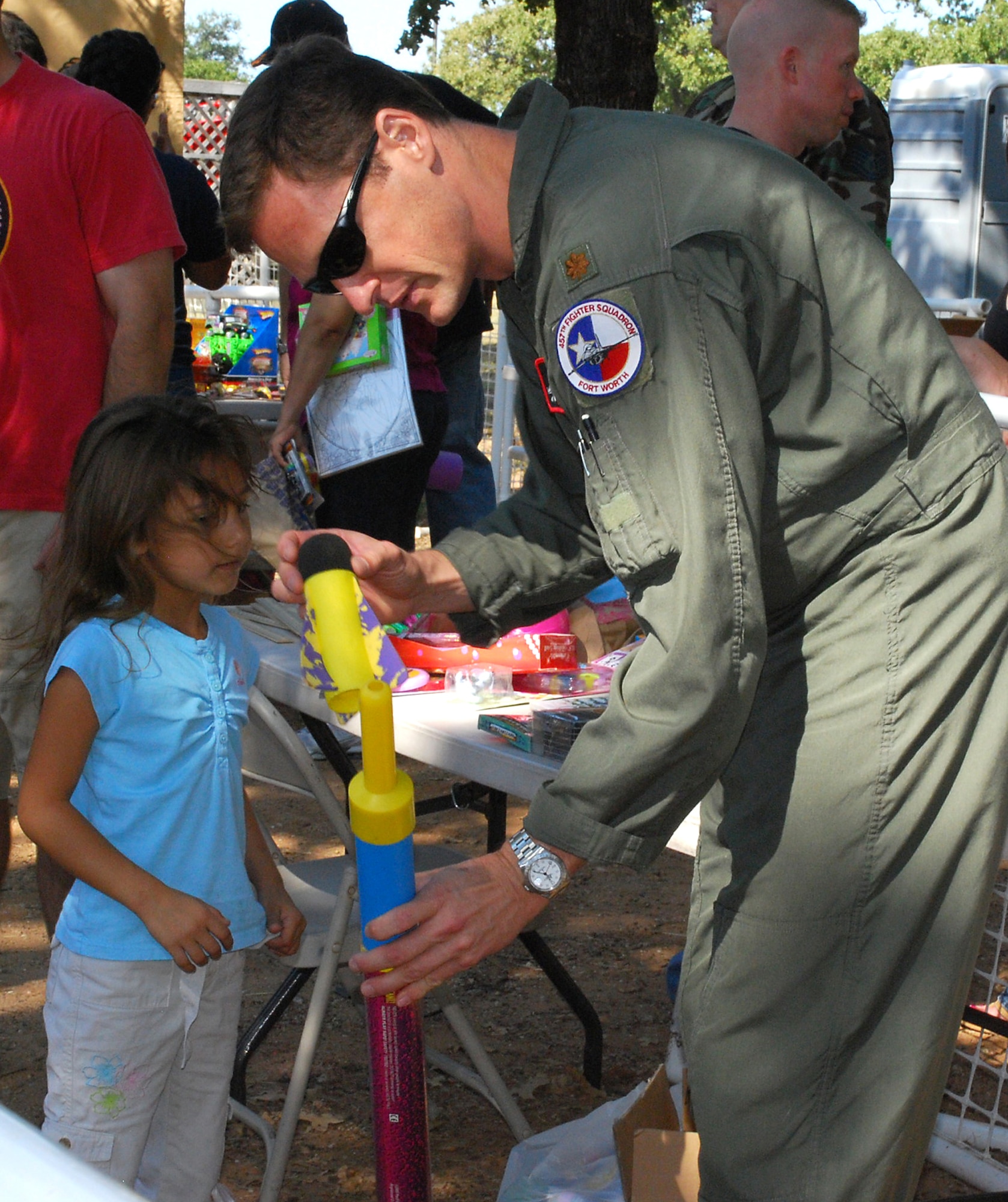 Even 457th Fighter Squadron F-16 pilots gave their time to help the children have fun. Ten booths offered different skill challenges for anyone willing to try free of charge. The picnic was held at the Naval Air Station Joint Reserve Base Fort Worth, Texas. (U.S. Air Force Photo/Tech. Sgt. Julie Briden-Garcia)