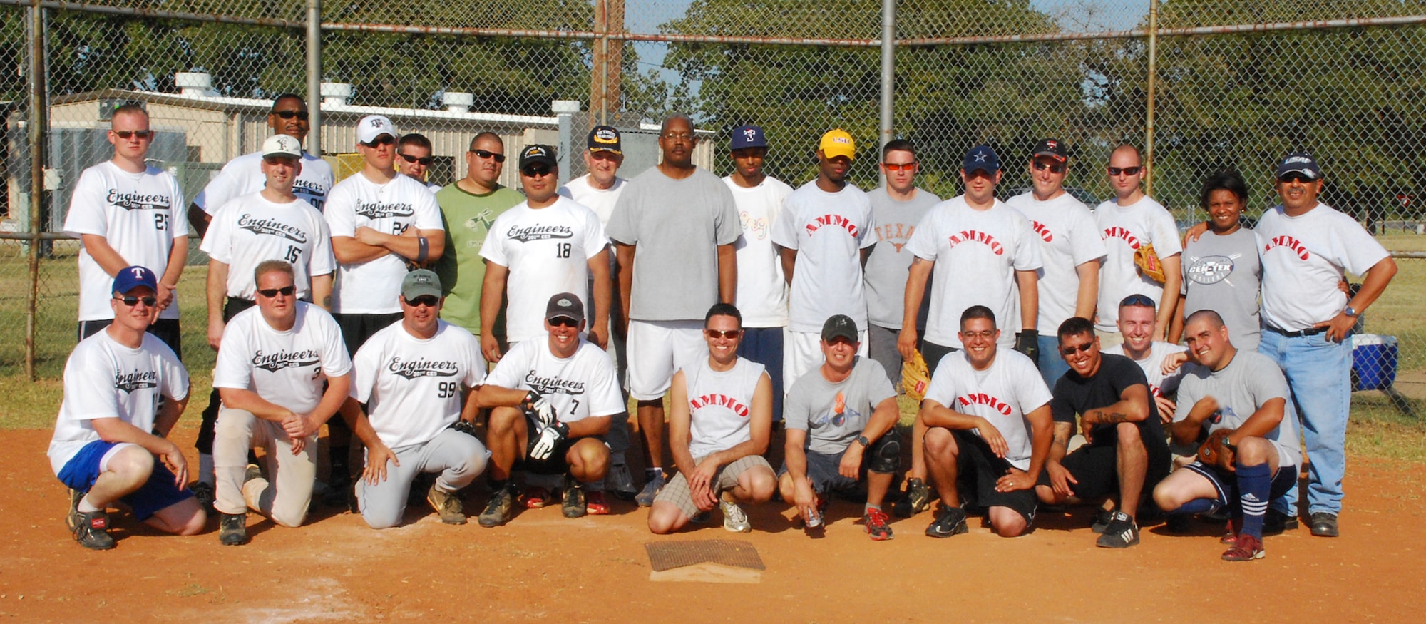 301st Civil Engineer Squadron (left half) took on the Ammo team (right half) and won this year?s Annual Family Day Picnic Softball Tournament. The two teams went head to head and CE won by more than double the point spread with a final score of 27 - 11. CES, whose playoff score averaged 30 points a game, now holds the bragging rights for the next year. (U.S. Air Force Photo/Lt. Col. John Moyer) 