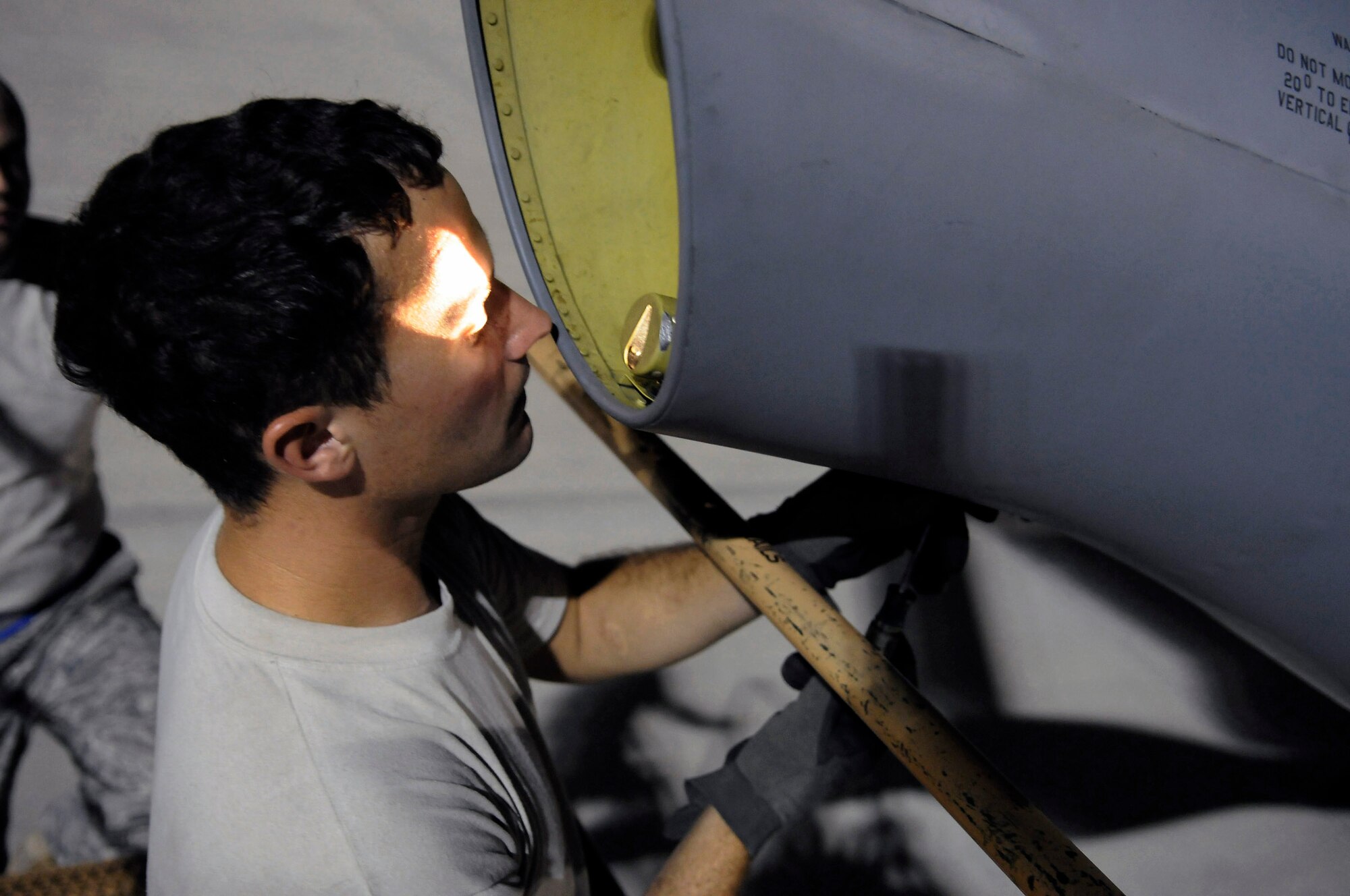 Staff Sgt. Ryan Letourneau adjusts a clamp after changing out the boom light on a KC-135 Stratotanker Oct. 27 at an air base in Southwest Asia. The KC-135 provides aerial refueling support to Air Force Navy, Marine Corps and allied nation aircraft operating in the Central Command area of responsibility. Sergeant Letourneau is assigned to the 379th Expeditionary Aircraft Maintenance Squadron. He is a native of Prosser, Wash., and is deployed from Fairchild Air Force Base, Wash. (U.S. Air Force photo/Tech. Sgt. Michael Boquette) 
