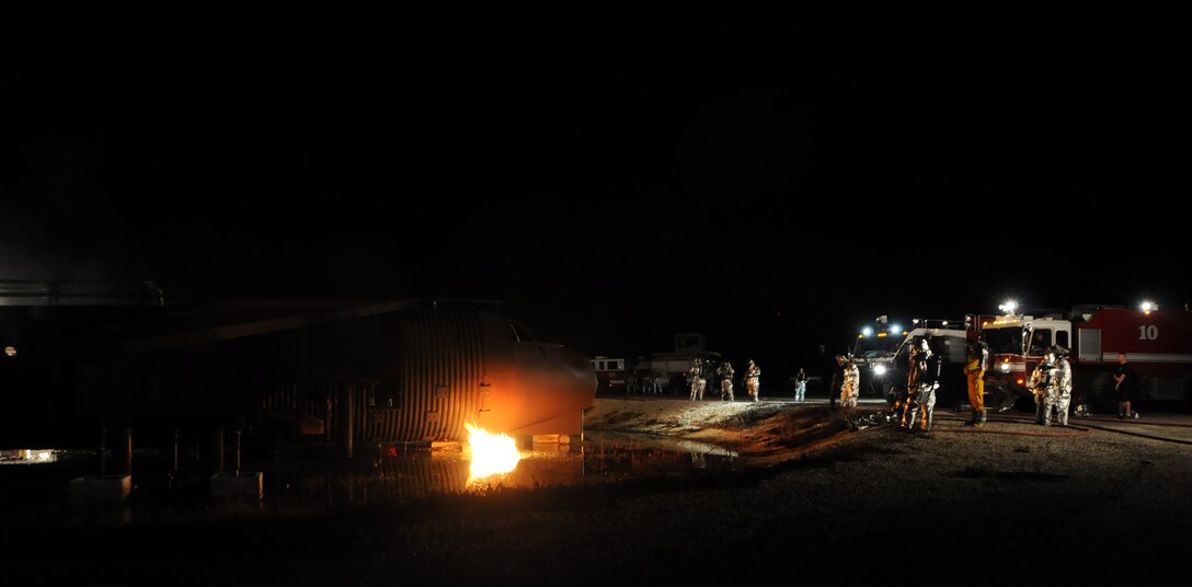ANDERSEN AIR FORCE BASE, Guam – Airmen from the 36th Civil Engineer Squadron Fire and Emergency Services Flight conduct live fire training with the aircraft fire simulator here Oct. 27. According to the Air Force regulations, firefighters must perform live fire training annually; however, fire personnel here conduct training quarterly to maintain proficiency. (U.S. Air Force photo by Airman 1st Class Courtney Witt)