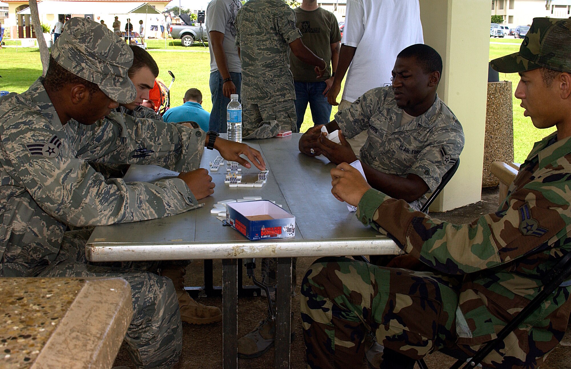 At the Junior Enlisted Appreciation Day event here Oct. 24, (Clock-wise from bottom-right) Airman 1st Class Brandon Gordon, Senior Airman Justin Harrison, Airman 1st Class George Bowser and Airman 1st Class Tereaud Morris, all of the 36th Communications Squadron, play a competitive game of dominoes. (U.S. Air Force photo by Airman 1st Class Carissa Wolff)                                                         