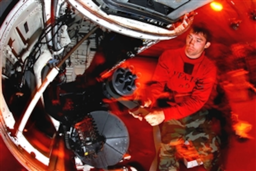 U.S. Navy Petty Officer 2nd Class Hunter Owens reinstalls an M-61A1 20mm Gatling gun in an F/A-18C Hornet aboard the aircraft carrier USS John C. Stennis in the Pacific Ocean, Oct. 26, 2008. 