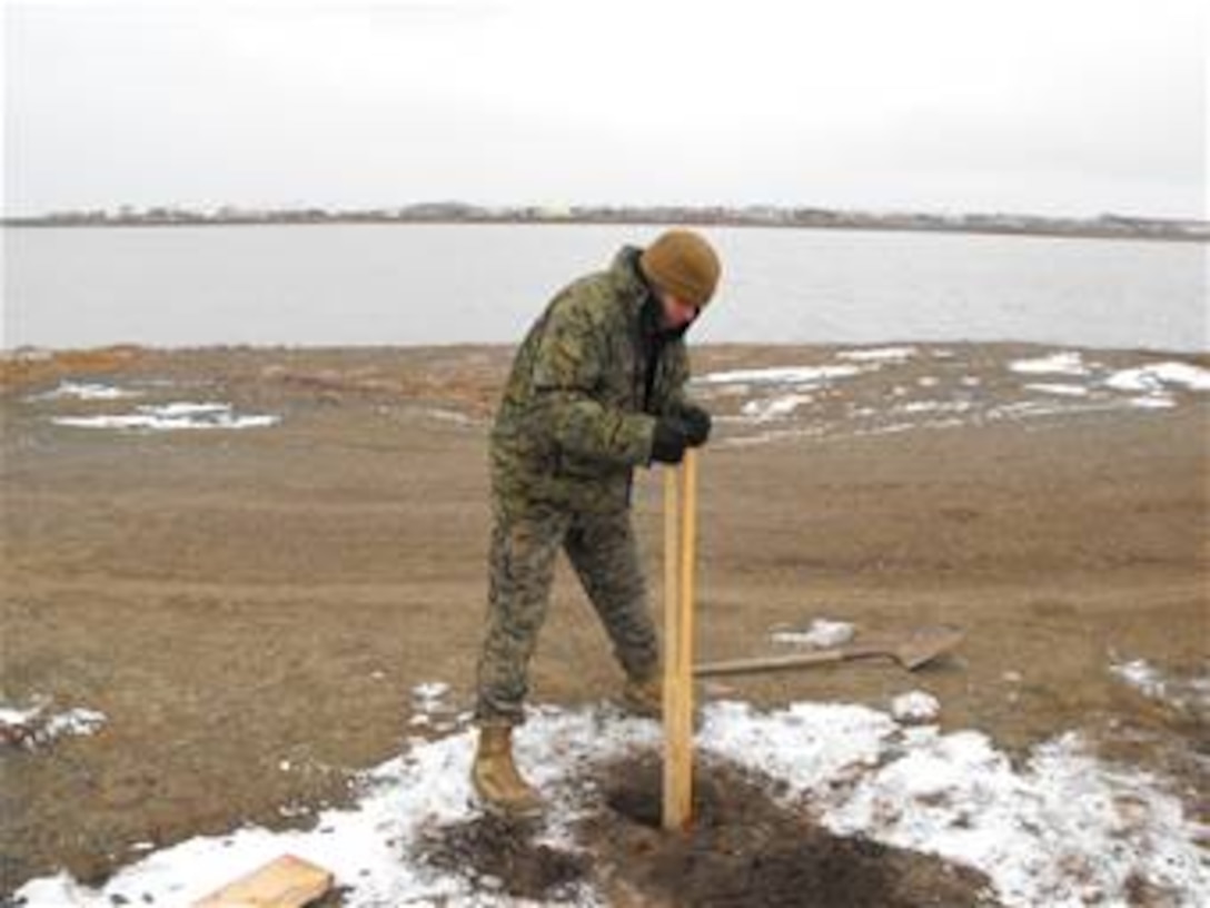 Marine Corp Lance Cpl. Jeremy Langford, digs a post hole during the D Company-Antiterrorism Battalion 4th Marine Division's trip here. The members of the company performed several community service projects and held their arctic survival training during the trip.