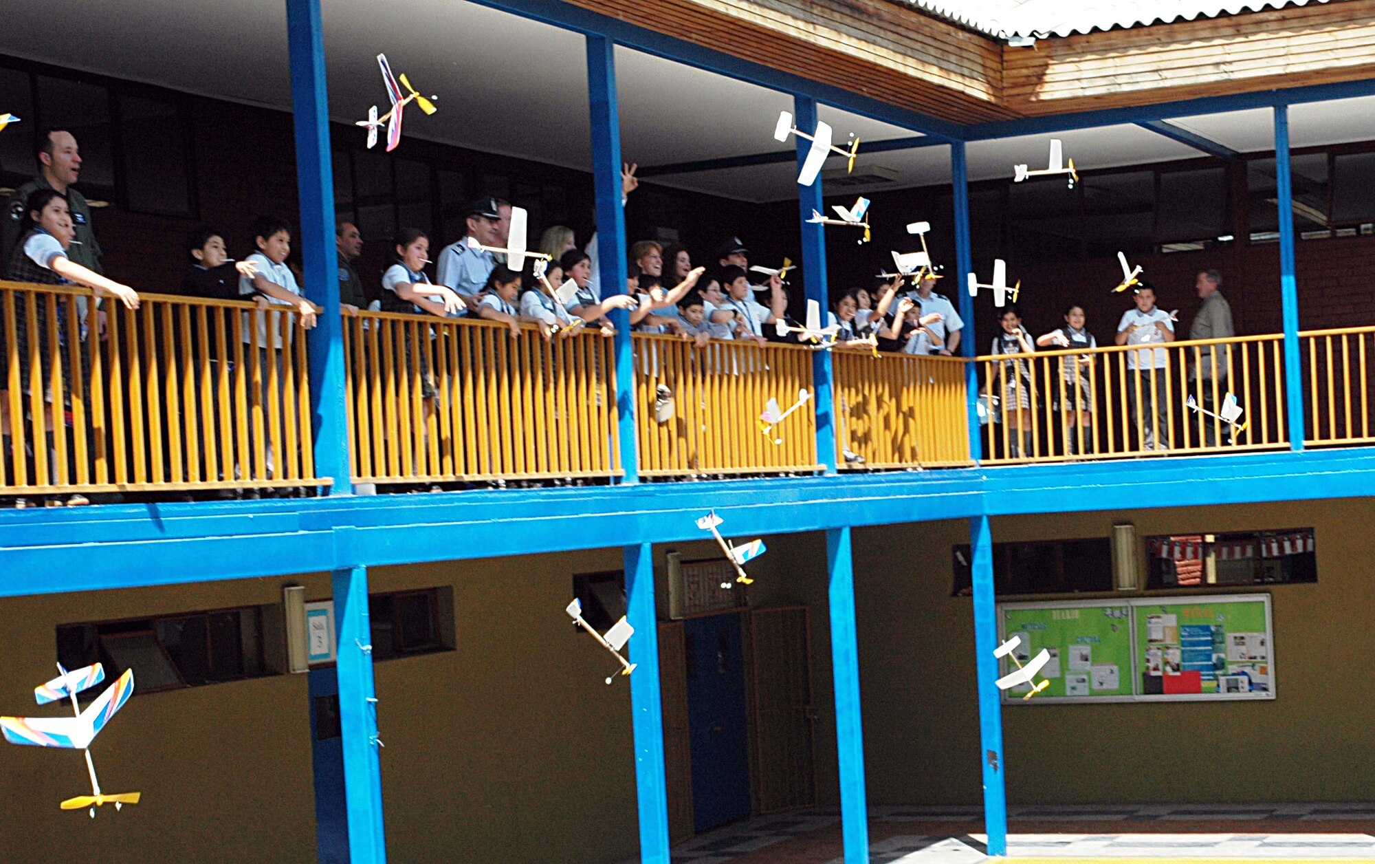 Children from the Complejo Educacional Esperanza School in Santiago, Chile launch their newly constructed model airplanes Oct. 27 following a community outreach event there to teach the children about applied sciences. The volunteer opportunity was the first of many scheduled in Latin America during Operation Southern Partner -- an Air Forces Southern-led event aimed at providing intensive, periodic subject matter exchanges with partner nations in the U.S. Southern Command area of focus.  The all-new program features more than 70 U.S. Air Force subject matter experts from about 25 career fields working alongside partner nation military members in similar career specialties during week-long exchanges. (U.S. Embassy photo/Jose Nuños)