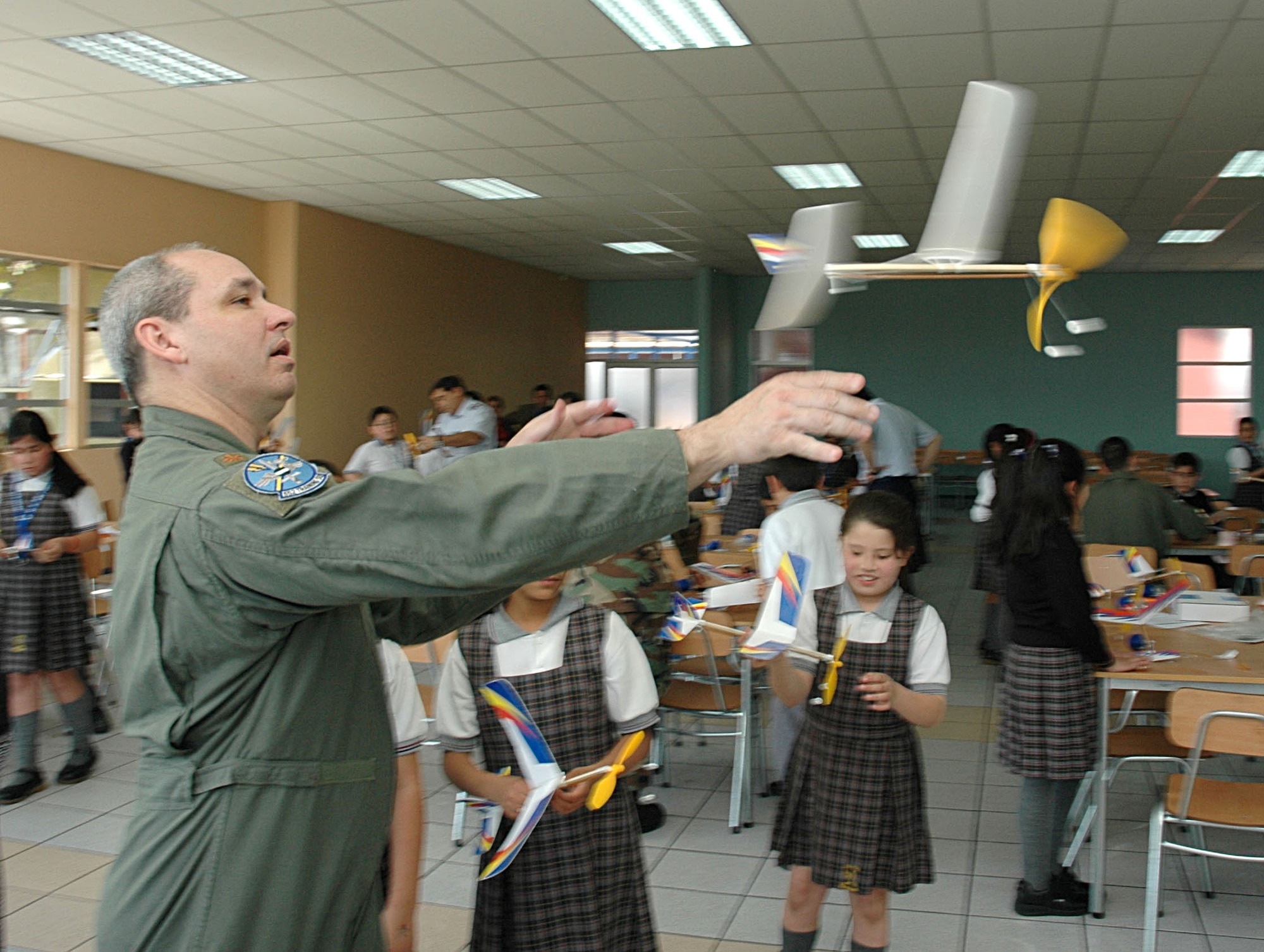Maj. Mark Jones, operations officer for the U.S. Military Group in Chile, tests his model airplane Oct. 27 during a community outreach program at the Complejo Educacional Esperanza School in Santiago, Chile. Major Jones volunteered alongside members of Air Forces Southern, Chilean air force, the U.S. Embassy, and civilian volunteers from a U.S. based technology firm. Agilent Technologies donated dozens of afterschool activities including the model aircraft to demonstrate the practical applications of science during planned community outreach events. The volunteer opportunity marked the beginning of Operation Southern Partner, an all-new program featuring more than 70 U.S. Air Force subject matter experts from about 25 career fields working alongside partner nation military members in similar career specialties during week-long exchanges. (U.S. Embassy photo/Jose Nuños)