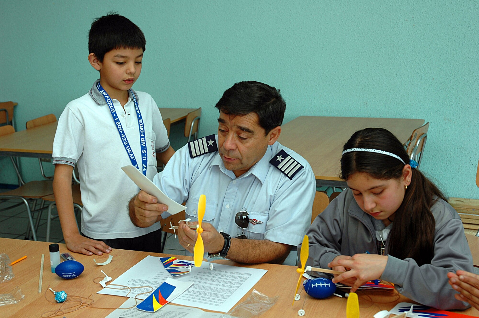 Col. Duncan Silva, Chilean air force director of public affairs, demonstrates model building Oct. 27 to Chilean children during an afterschool science program. The Chilean air force teamed up with members of Air Forces Southern, U.S. Embassy and Military Group, along with civilian volunteers from the Santa Clara, Calif.-based technology firm Agilent Technologies. The event is part of community outreach efforts complementing Operation Southern Partner, an AFSOUTH-led event aimed at providing intensive, periodic subject matter exchanges with partner nations in the U.S. Southern Command area of focus.  The all-new program features more than 70 U.S. Air Force subject matter experts from about 25 career fields working alongside partner nation military members in similar career specialties during week-long exchanges. (U.S. Embassy photo/Jose Nuños)