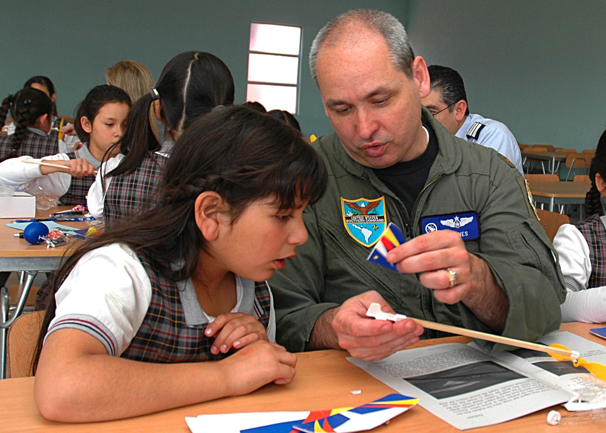 Maj. Mark Jones, operations officer for the U.S. Military Group in Chile, assists a a student at the Complejo Educacional Esperanza School in Santiago, Chile, during a community outreach event on Oct. 27. The outreach program is part of Operation Southern Partner, an Air Forces Southern-led exchange aimed at providing intensive, periodic subject matter exchanges with partner nations in the U.S. Southern Command area of focus. (U.S. Embassy photo/Jose Nuños)