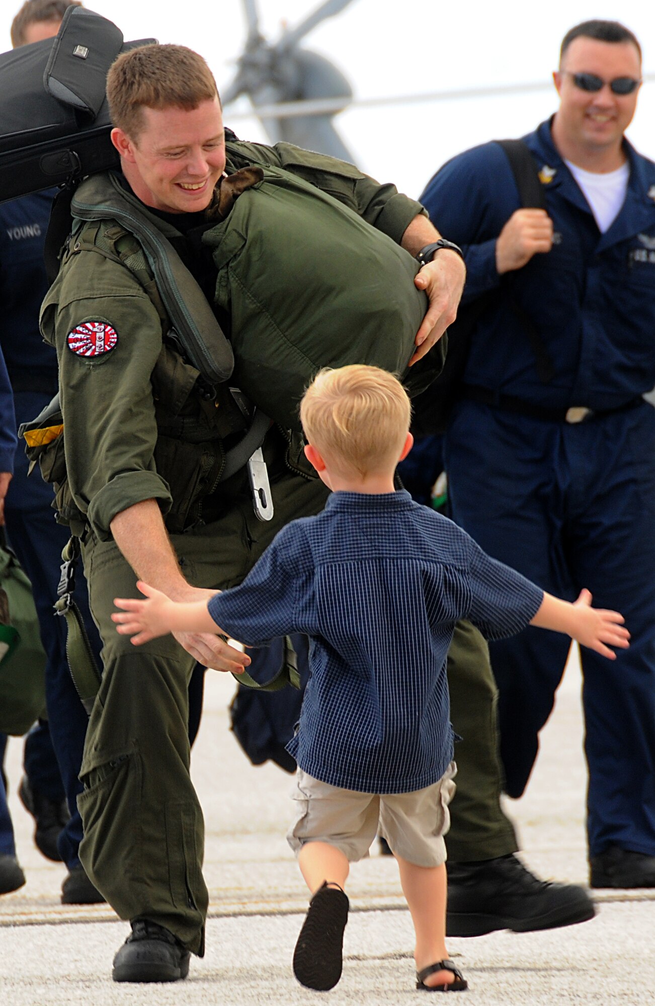 ANDERSEN AIR FORCE BASE, Guam - Trenton Wyandt barely gave his dad, AW1 Nicholas Wyandt, a chance to step foot on the tarmac before running to meet him on Oct. 29 here.  Trenton was just one of approximately 50 family members awaiting the return of Helicopter Sea Combat Twenty-Five Detachment 1 after a nine-month deployment to the Western Pacific. (U.S. Air Force photo by Staff Sgt. Jamie Lessard)