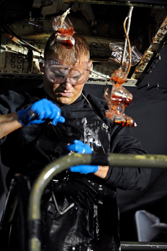 Airman 1st Class Bryce Woodall, 28th Aircraft Maintenance Squadron hydraulics systems apprentice, chooses a wrench to remove bolts from a flap slat power drive unit of a B-1B Lancer here, Oct. 29. The flap slat PDU controls the flaps and slats ability to retract during takeoffs and landings. (U.S. Air Force photo/Airman Matthew Flynn)