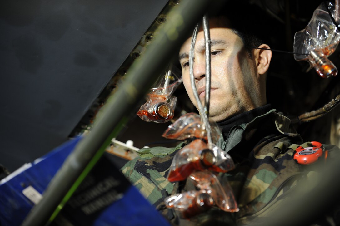 Staff Sgt. Anthony Franchina, 28th Aircraft Maintenance Squadron hydraulics systems craftsman, reads an instruction manual on the proper techniques for removing flap slat power drive unit from a B-1 Bomber here, Oct. 29. The unit is essential to the retrieving flaps for landing and taking off. (U.S. Air Force photo/Airman 1st Class Adam Grant)