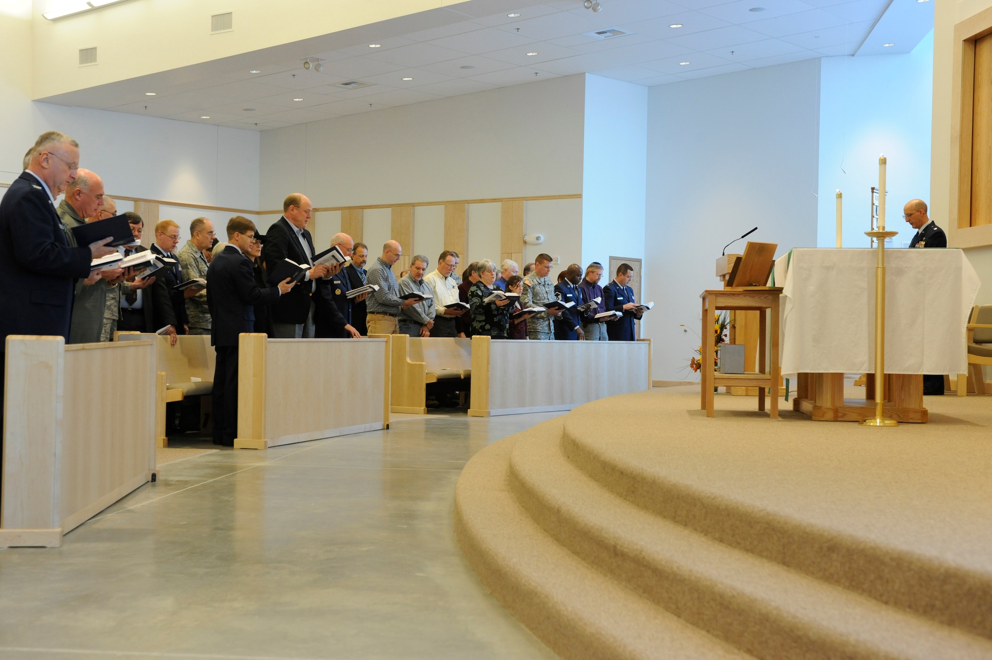 Chaplain (Lt. Col.) David Terrinoni leads the congregation in song during the base chapel dedication ceremony Oct. 29, 2008, at Eielson Air Force Base, Alaska. The chapel staff hosted a dedication ceremony for the new 29,000 sq. ft. facility that will serve as a multi-faith worship center for many future generations at Eielson.  (U.S. Air Force photo/Senior Airman Jonathan Snyder)